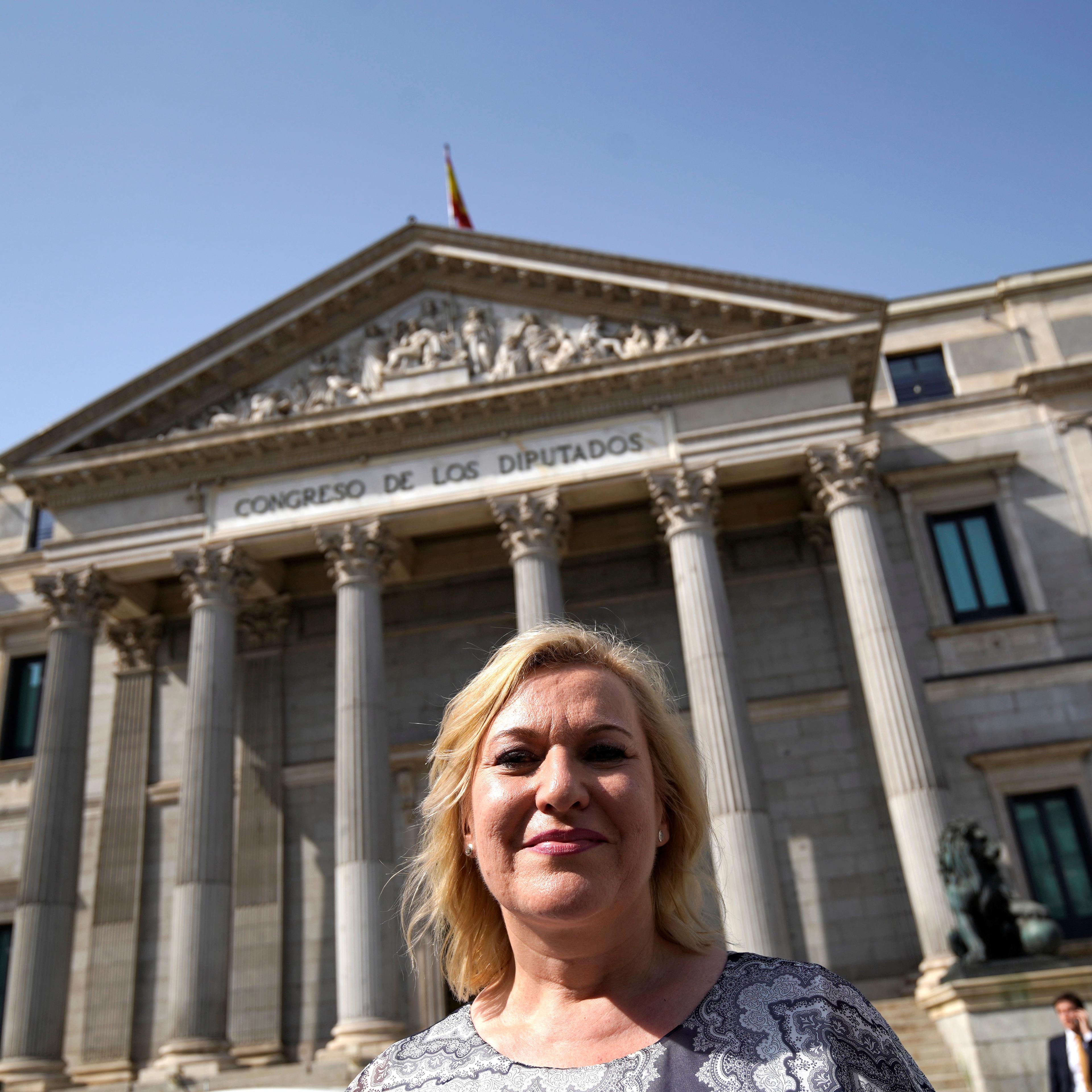 Ines Madrigal, who alleges she was one of Spain's "stolen babies" and has taken former doctor Eduardo Vela to court for falsifying her birth certificate to give her to her adoptive mother, poses outside Parliament building in Madrid