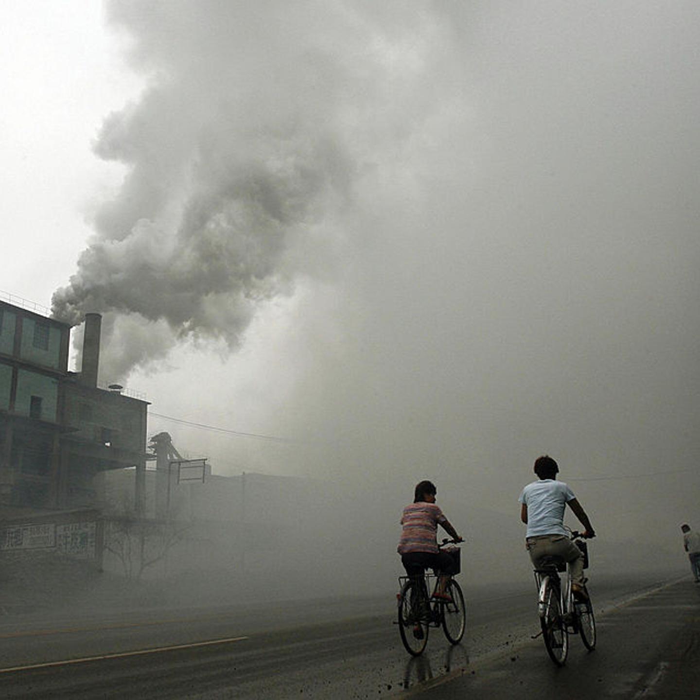 This 2006 picture shows cyclists passing through thick pollution from a factory in Yutian, east of Beijing in China's northwest Hebei province.