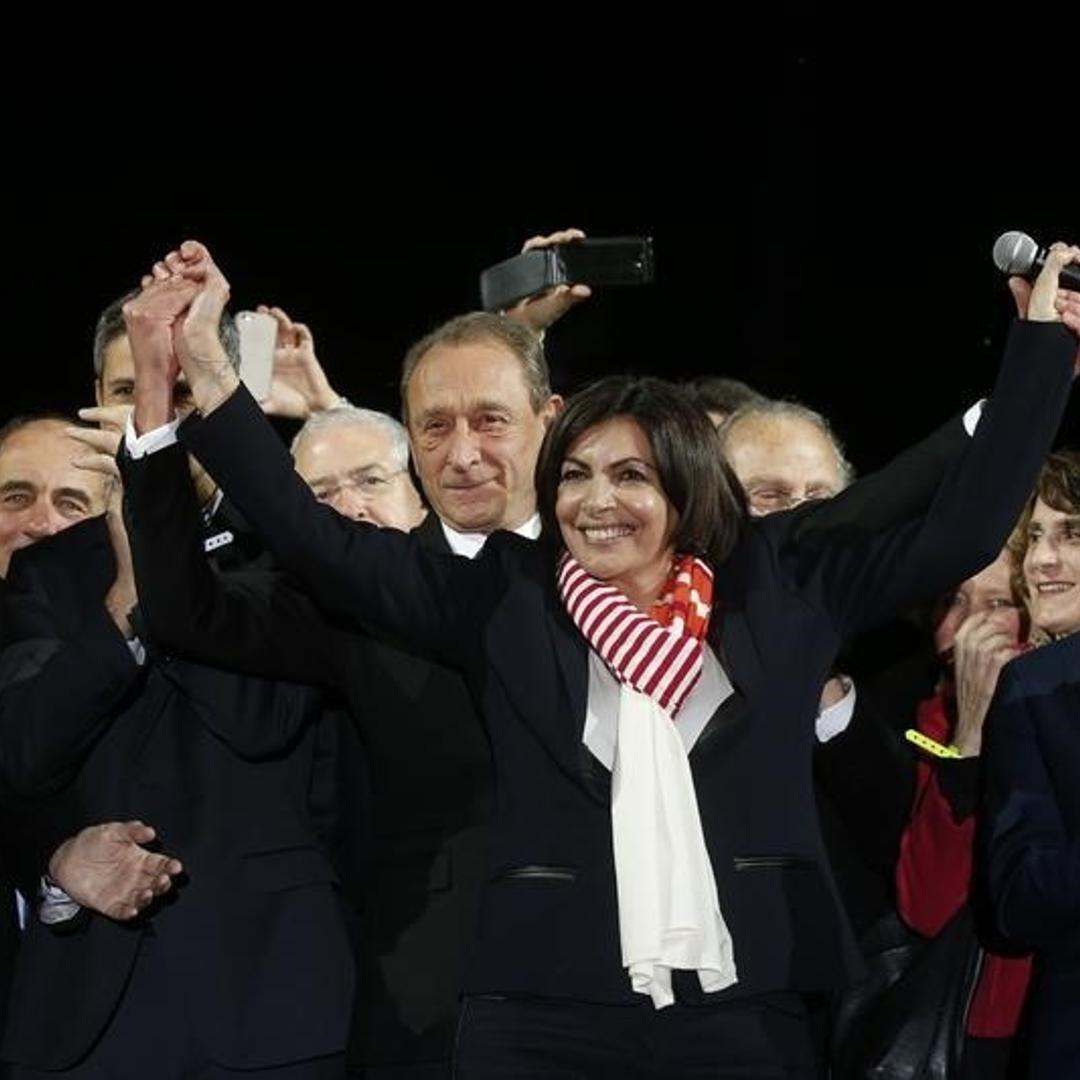 Former Mayor of Paris Bertrand Delanoe and his newly-elected successor Anne Hidalgo celebrate her victory at City Hall Plaza on March 30, 2014 in Paris.