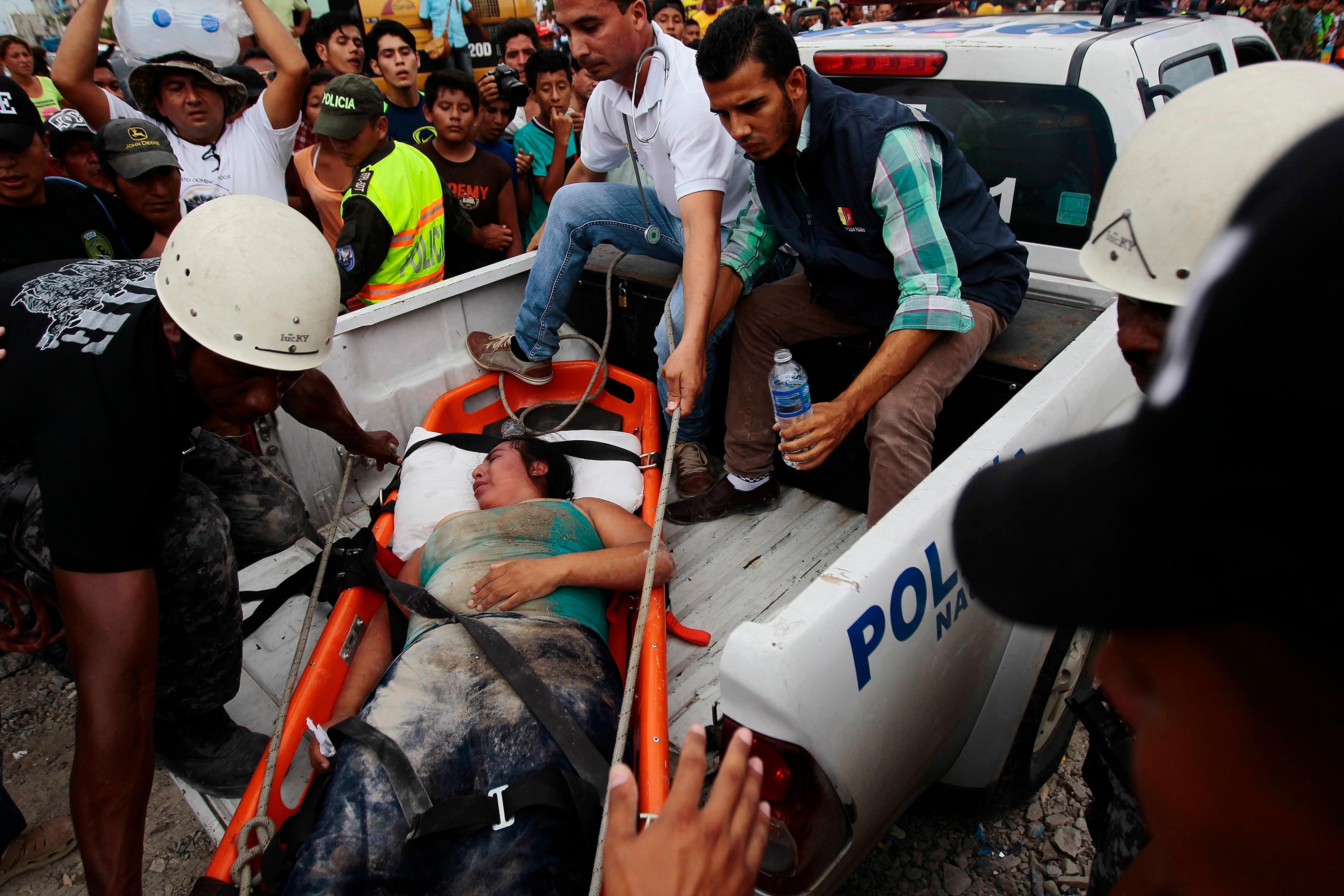 An injured woman is carried on a stretcher into a vehicle by a team of emergency services in Pedernales, Ecuador, April 17, 2016. A 7.8-magnitude earthquake hit the northern Ecuadoran coastal region the day earlier, killing at least 400 people as rescue