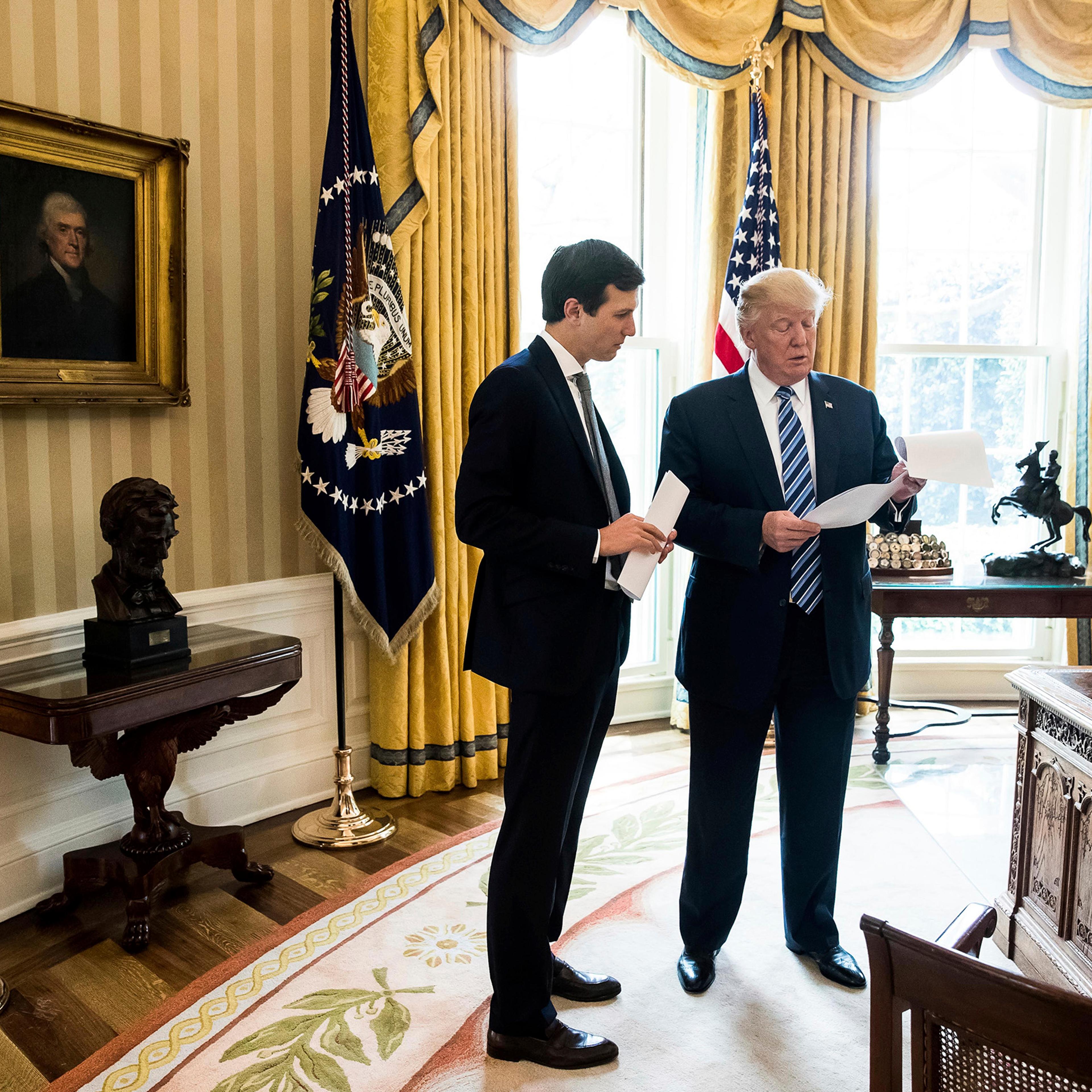 President Donald Trump speaks to his son- in-law White House Senior Adviser Jared Kushner, left, in the Oval Office in Washington, Friday, April 21, 2017.