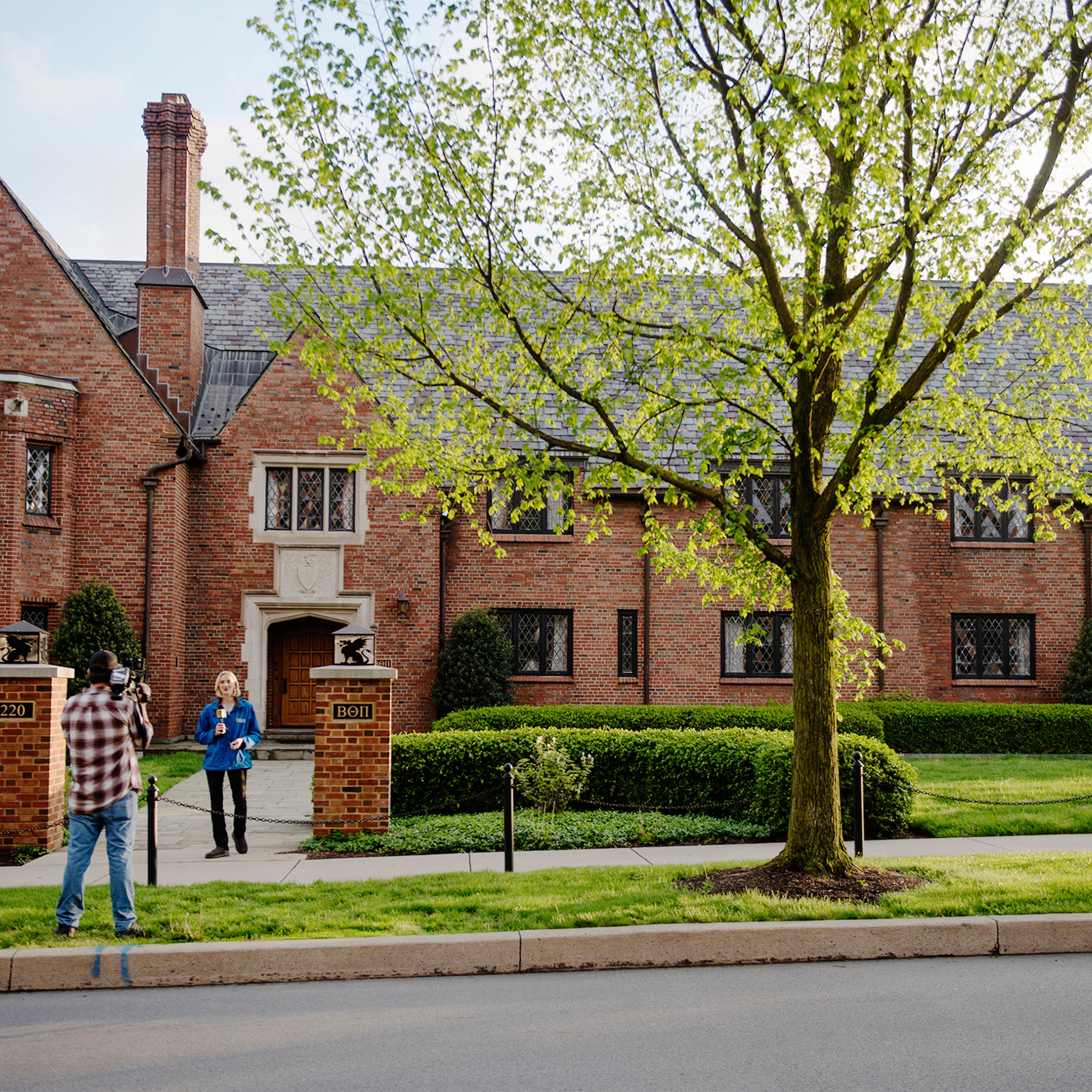 Reporters shoot a news standup outside the Penn State University Beta Theta Pi fraternity house on campus on May 5, 2017 in State College.