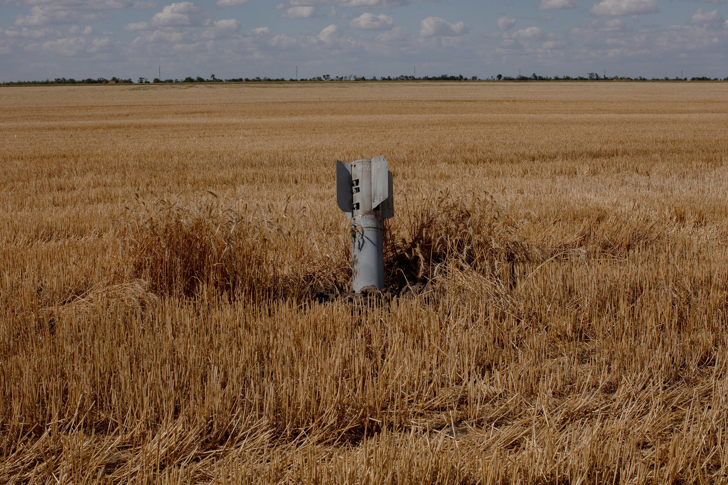 An unexploded rocket loaded with cluster munitions in a wheat field in Mykolaiv, Ukraine, on July 22. Nadiia runs a large farming operation between Mykolaiv city and Kherson, and her farm was on the front lines when Russia invaded the city at the start of the war before Ukrainians were able to push them back. Shelling in the area is a daily occurrence.