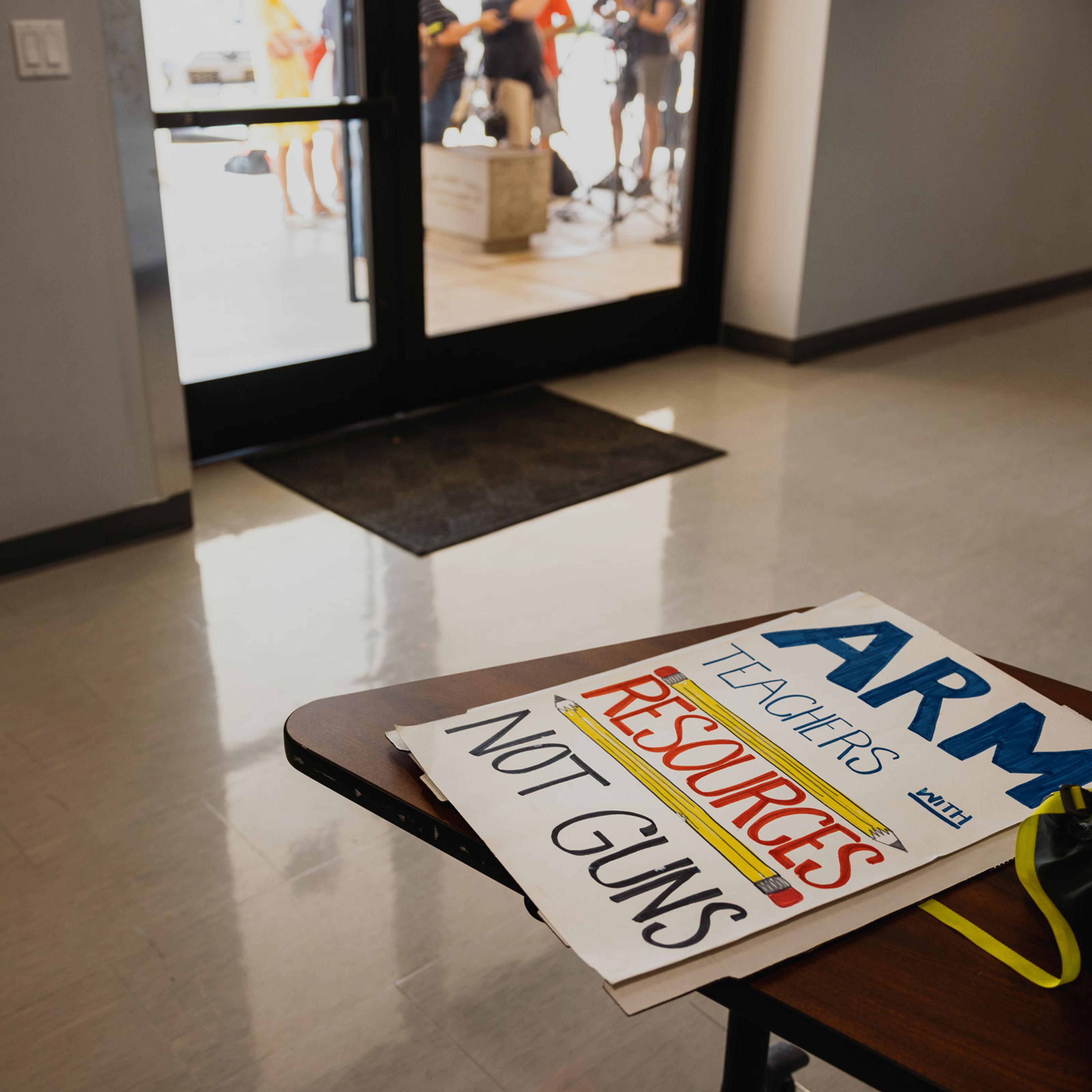 A sign at the AFLCIO office before demonstrators with the Texas American Federation of Teachers prepare to march, reading “Arm teachers with resources not guns”