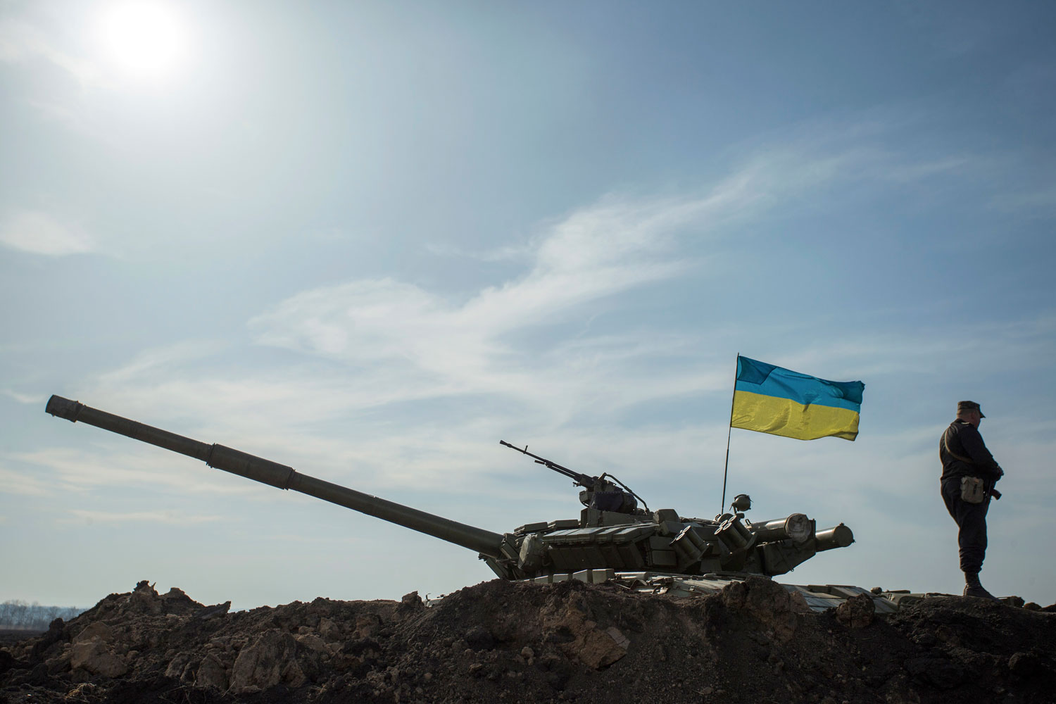 A soldier stands guard near a tank position close to the Russian border near the Ukranian city of Kharkiv March 24, 2014.