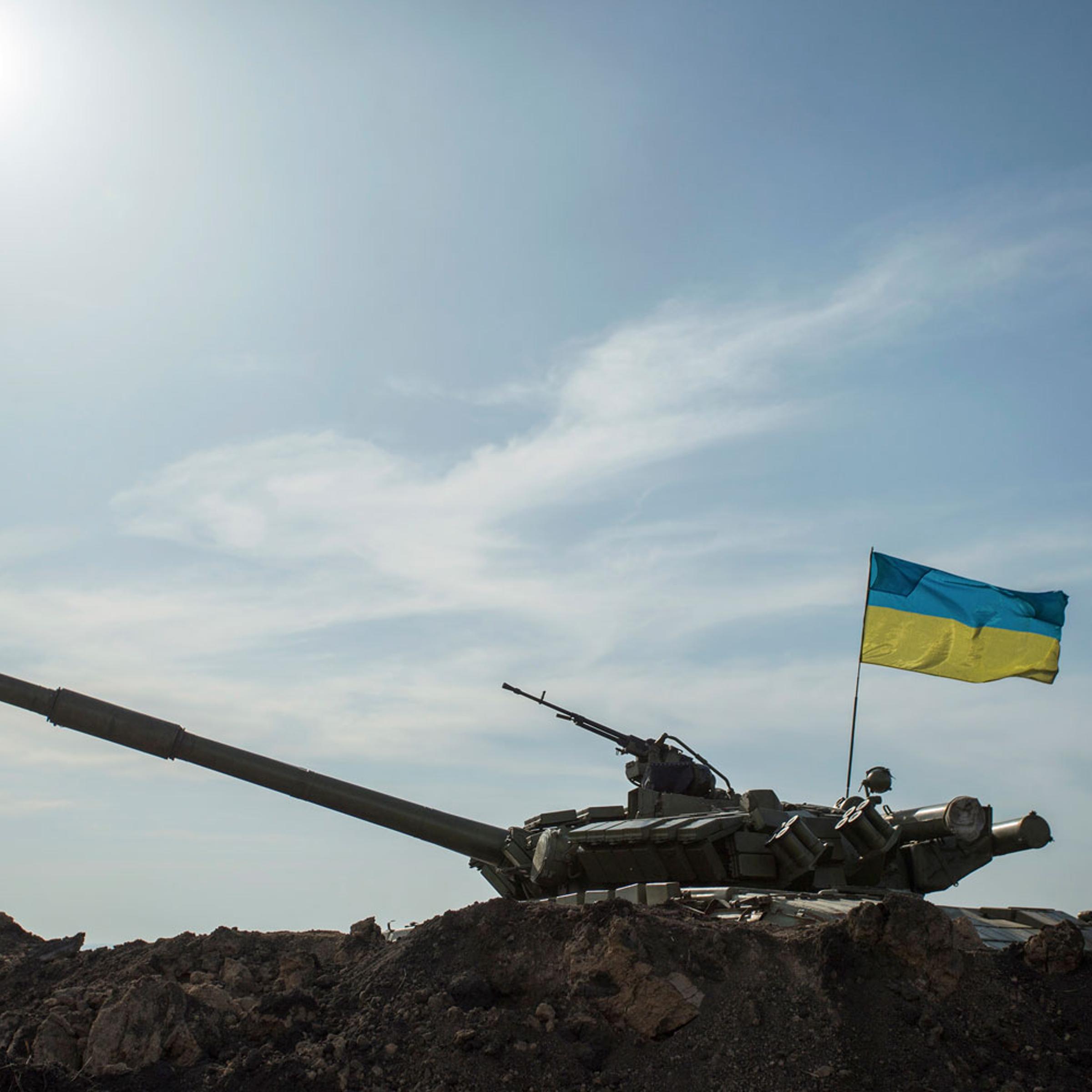 A soldier stands guard near a tank position close to the Russian border near the Ukranian city of Kharkiv March 24, 2014.