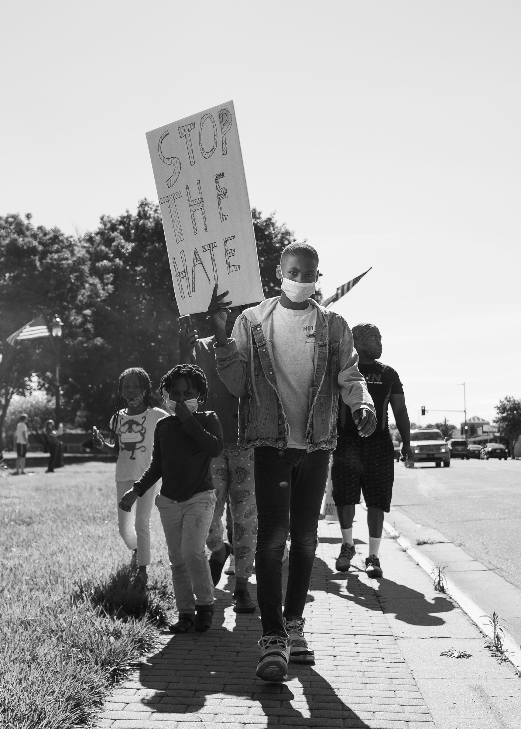 Jason Allende, 13, walks before his mother and siblings, protesting the death of George Floyd in Junction City, Kans., May 29, 2020.