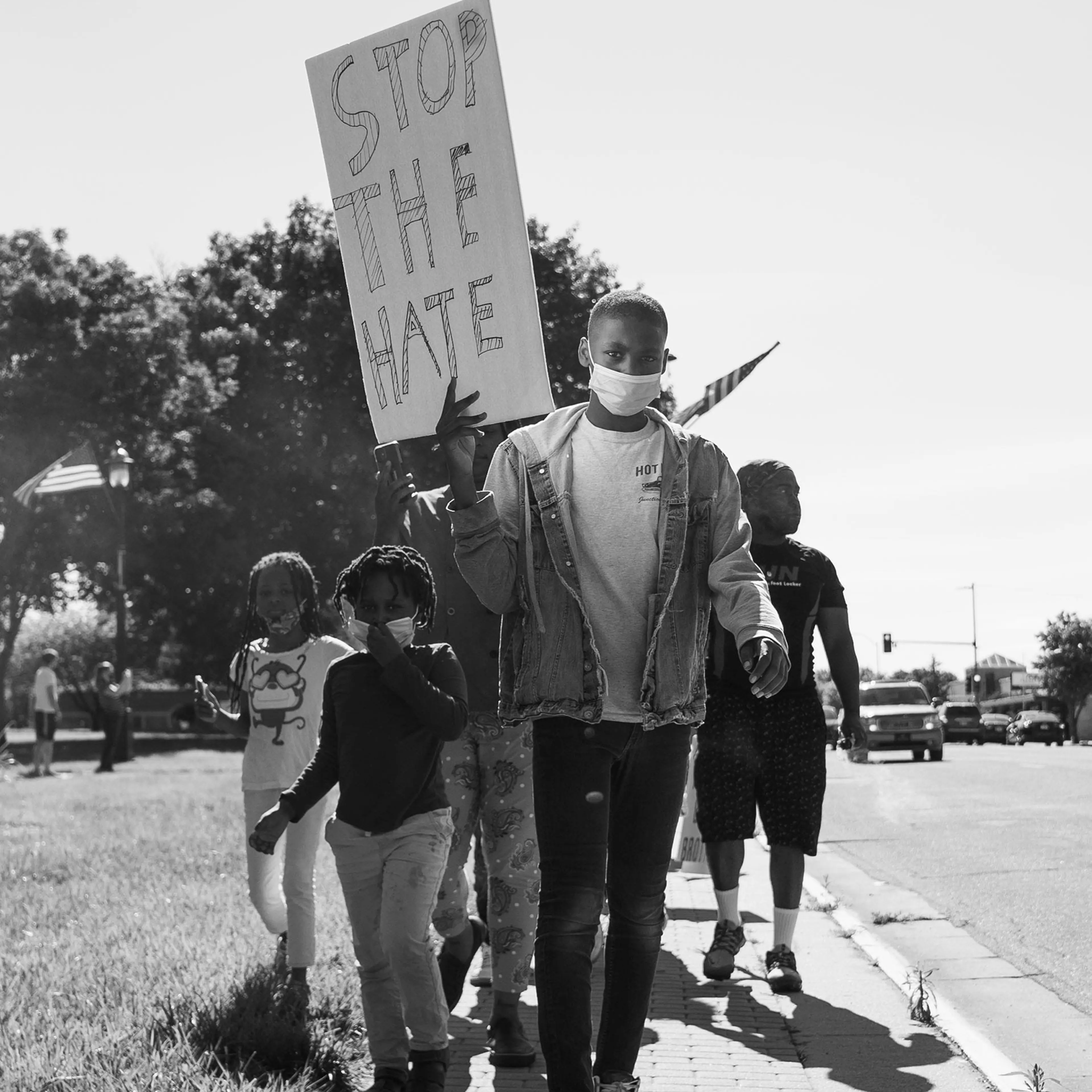 Jason Allende, 13, walks before his mother and siblings, protesting the death of George Floyd in Junction City, Kans., May 29, 2020.