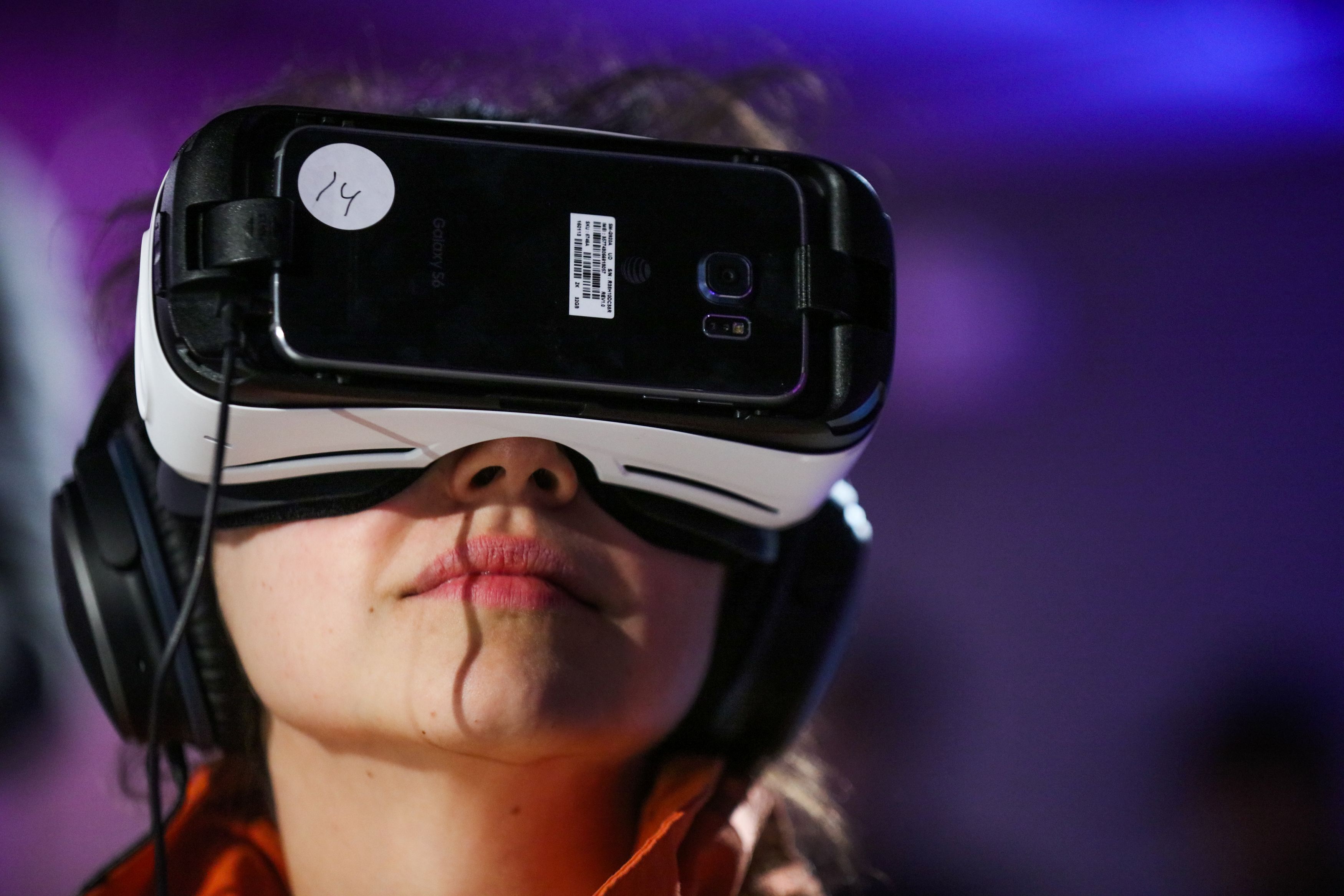 Anna Chif, of Diagram, wears Oculus goggles and the Samsung Gear VR headset, while experiencing Minecraft for Gear VR during a press demonstration, in San Francisco, California on March 15, 2016.