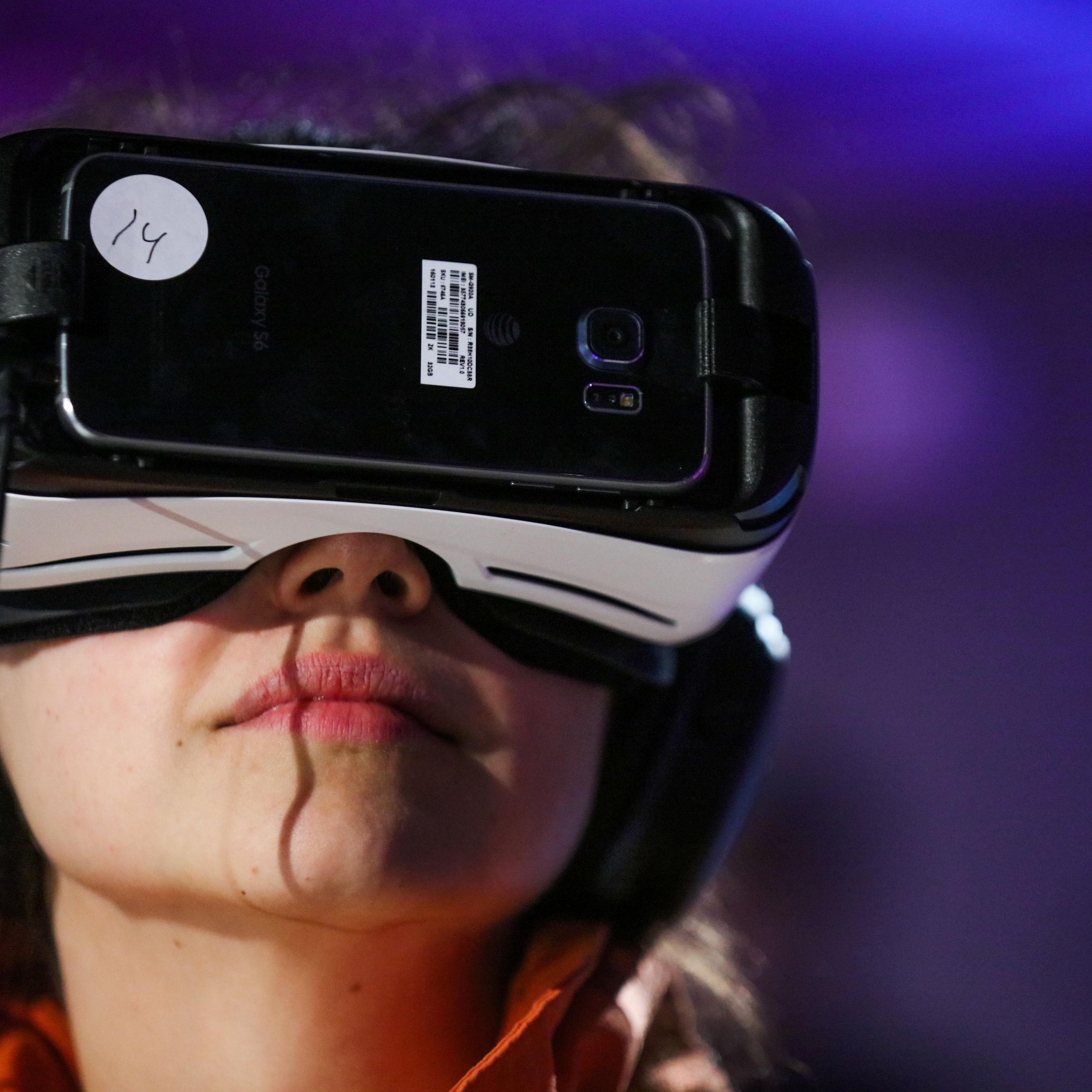 Anna Chif, of Diagram, wears Oculus goggles and the Samsung Gear VR headset, while experiencing Minecraft for Gear VR during a press demonstration, in San Francisco, California on March 15, 2016.