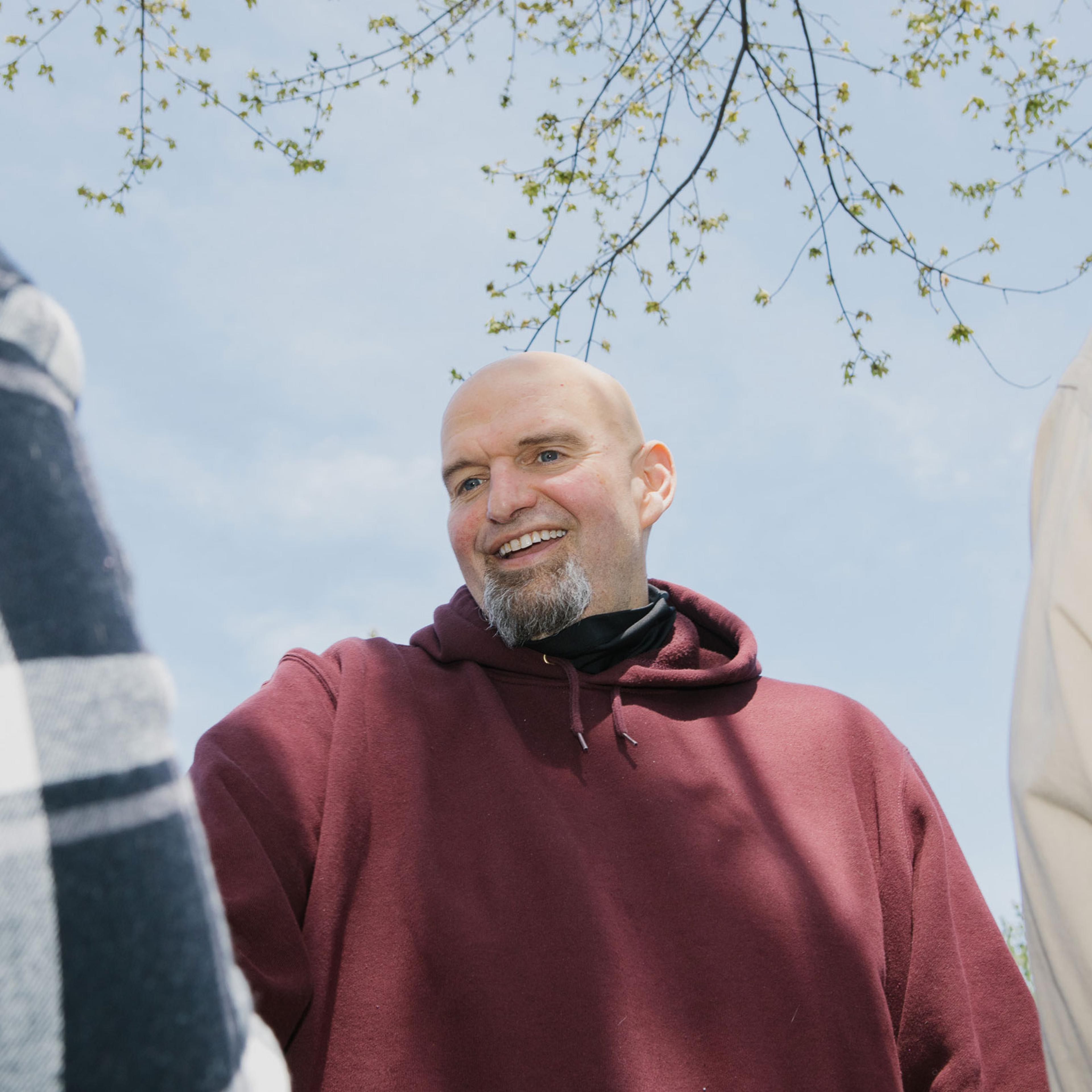 John Fetterman speaks with attendees during a campaign event