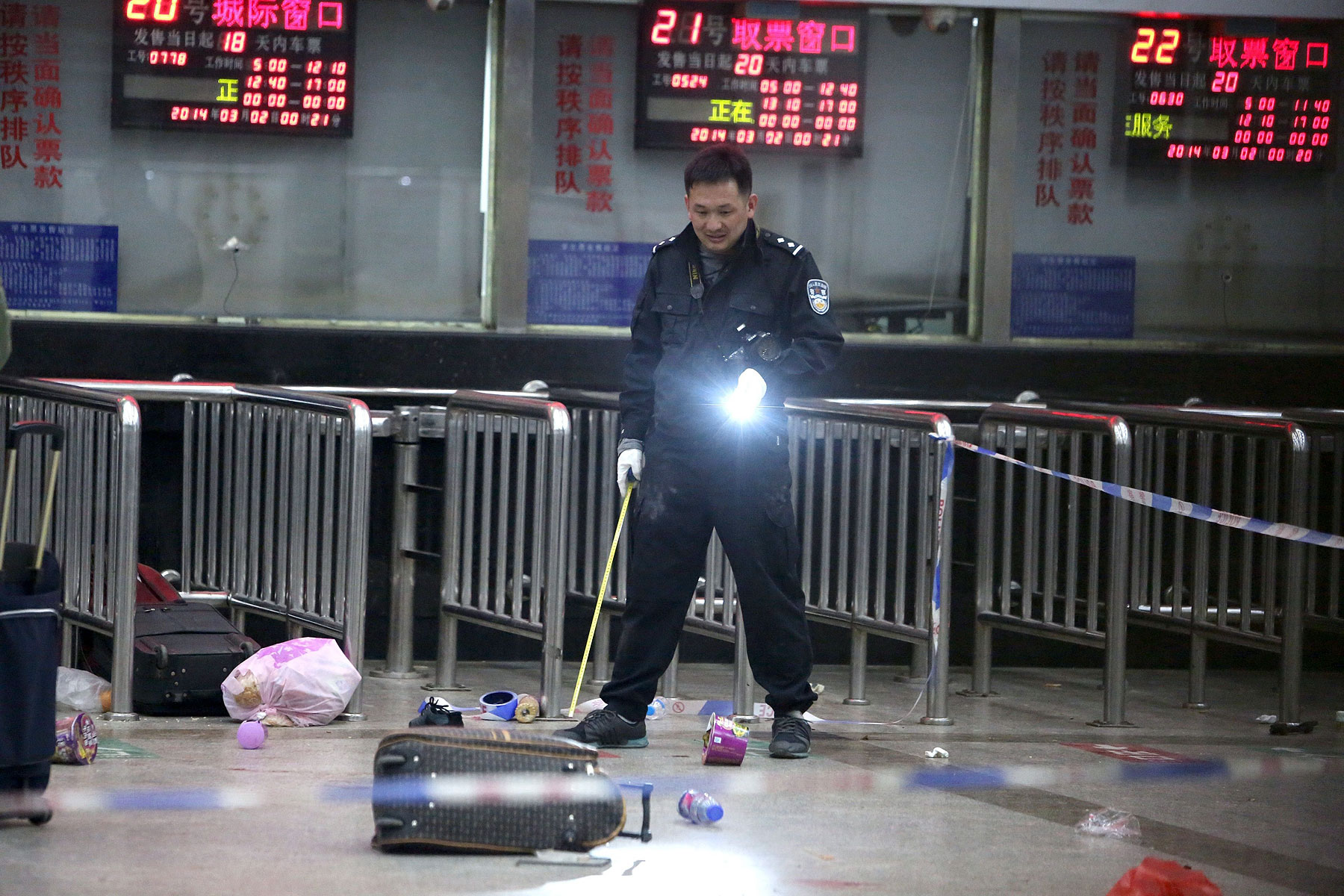 A Chinese police investigator in Kunming’s railway station after the March 1 mass knifings that killed 29 people and injured scores