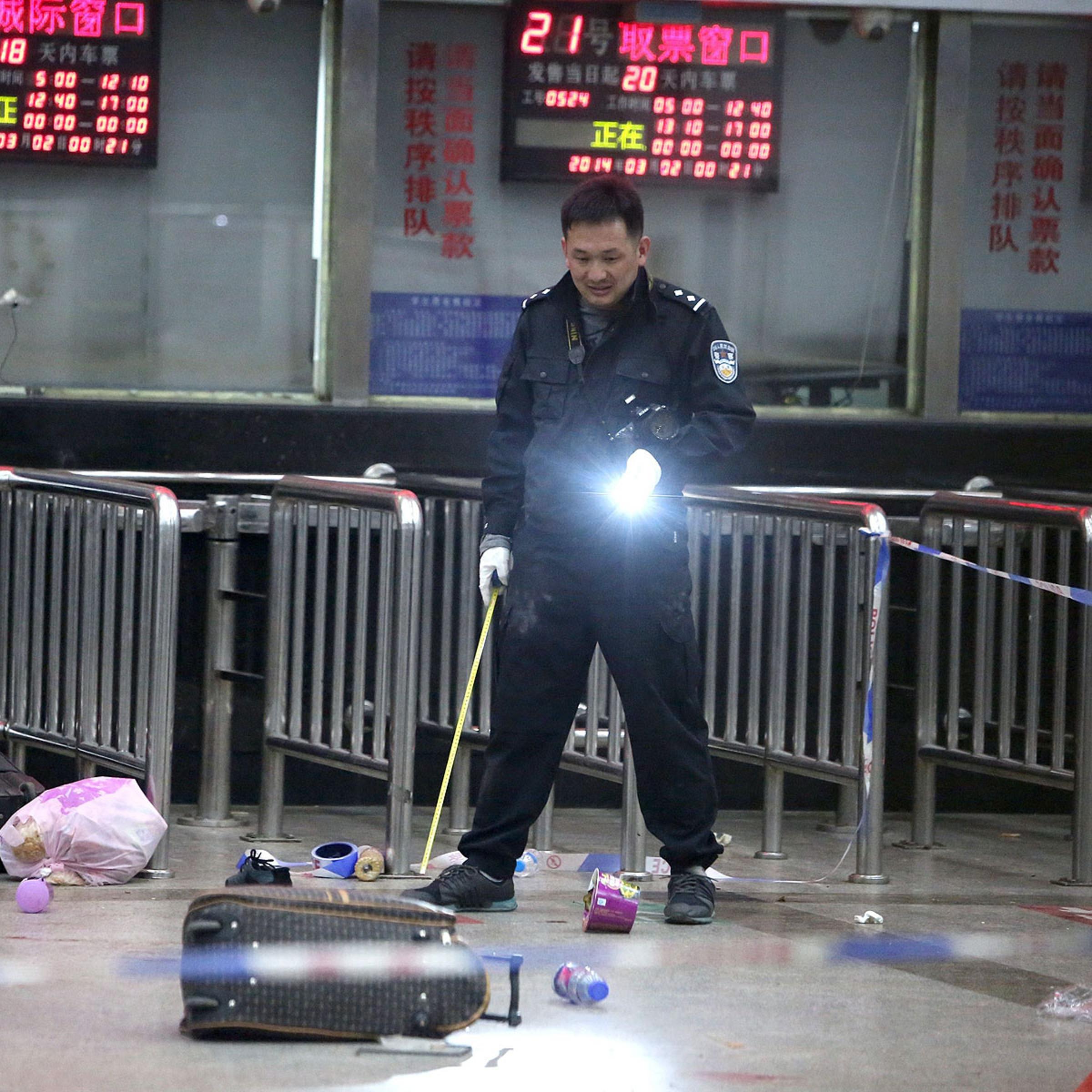 A Chinese police investigator in Kunming’s railway station after the March 1 mass knifings that killed 29 people and injured scores