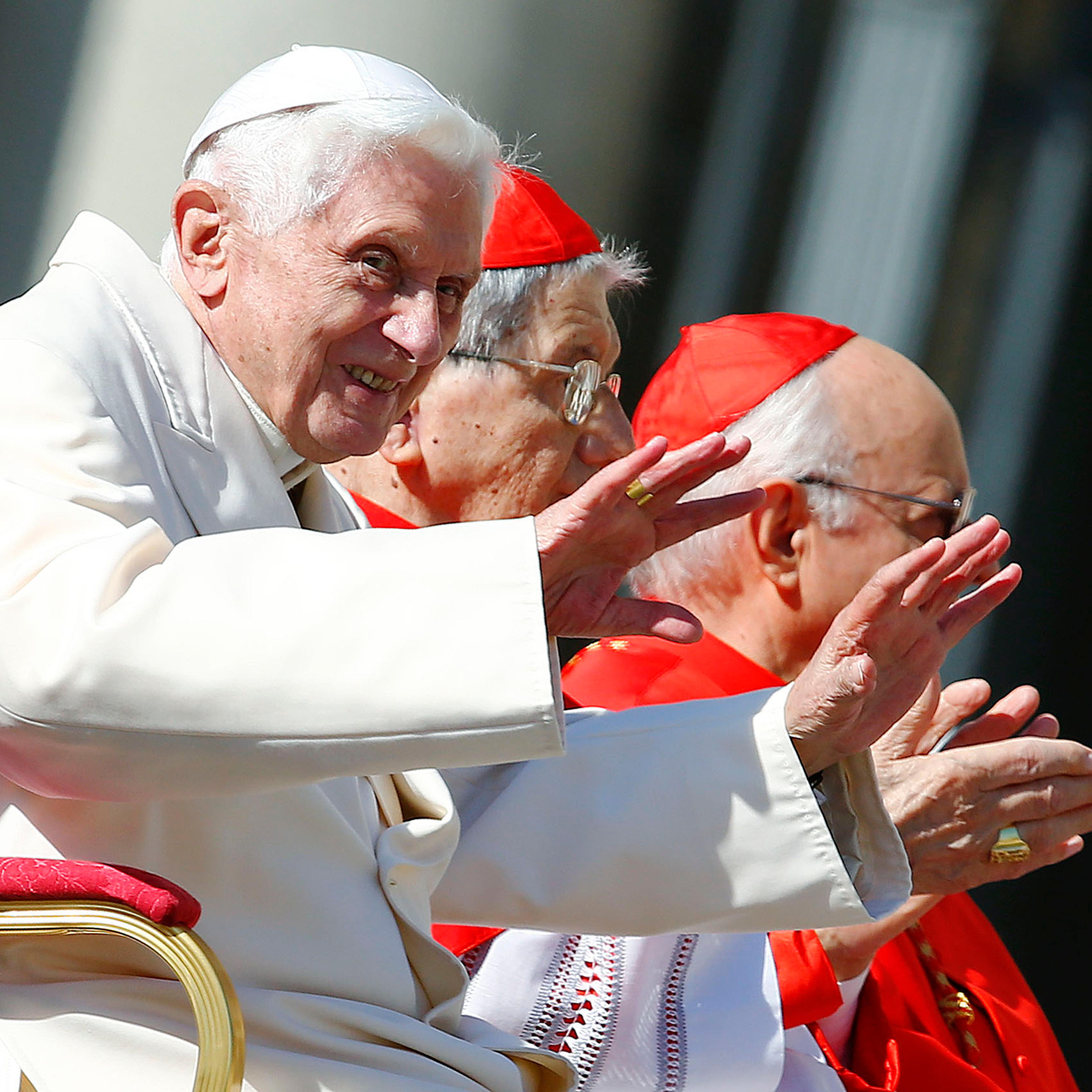 Emeritus Pope Benedict XVI waves before a mass in Saint Peter's square at the Vatican, Sept. 28, 2014.