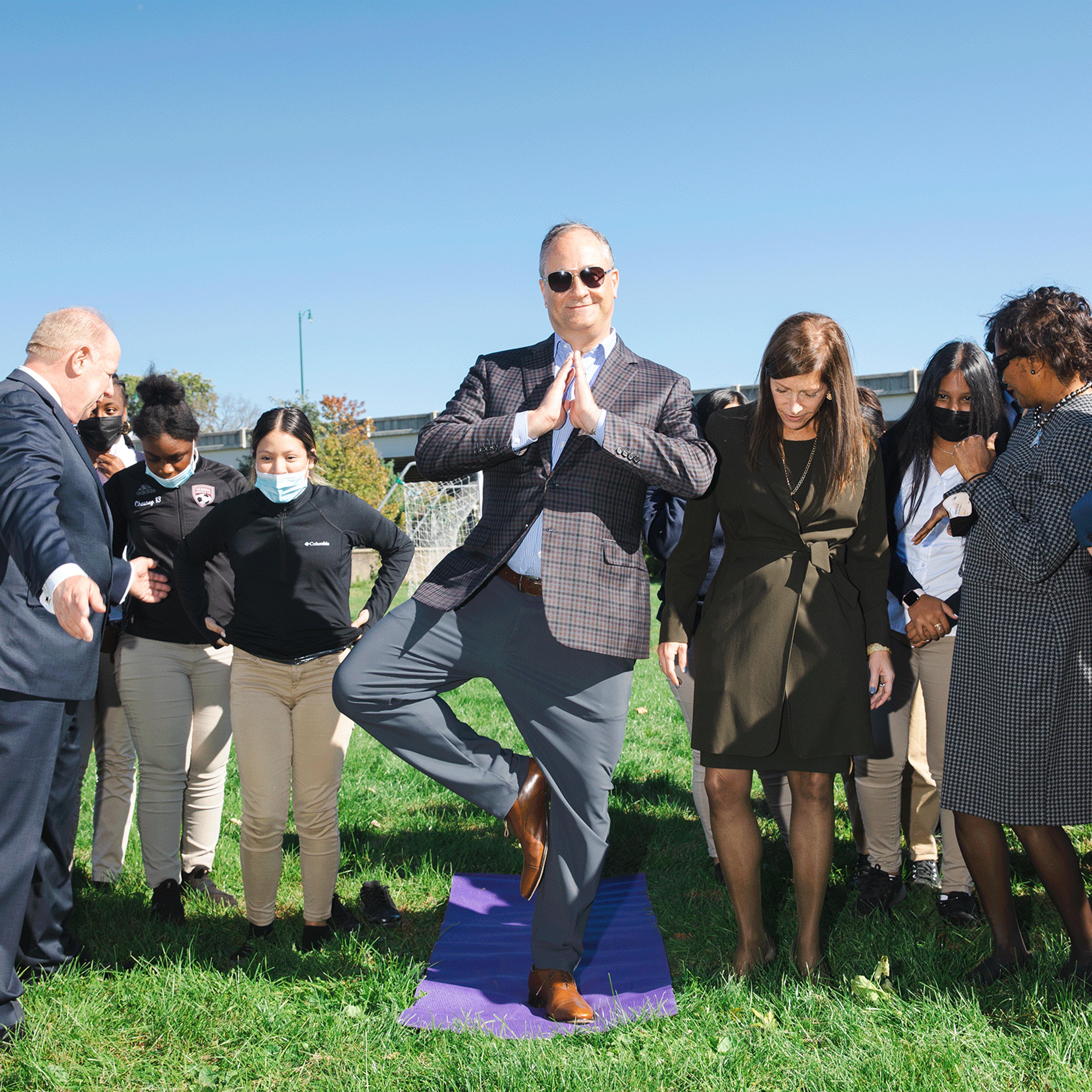Emhoff practices his tree pose with a yoga class during a visit to New Jersey on Oct. 19, 2021.