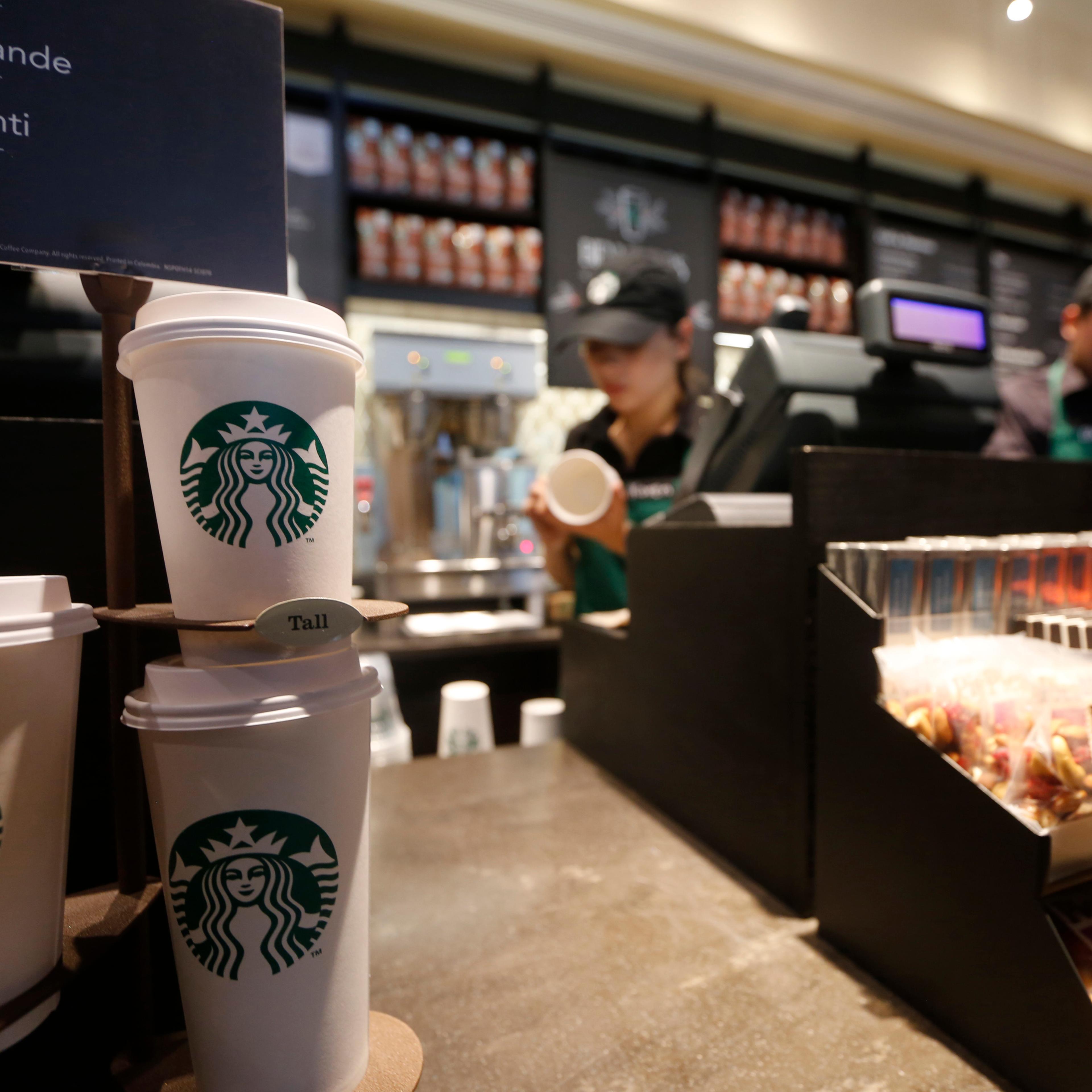 Paper cups of different sizes are seen on display at Starbuck's first Colombian store at 93 park in Bogota