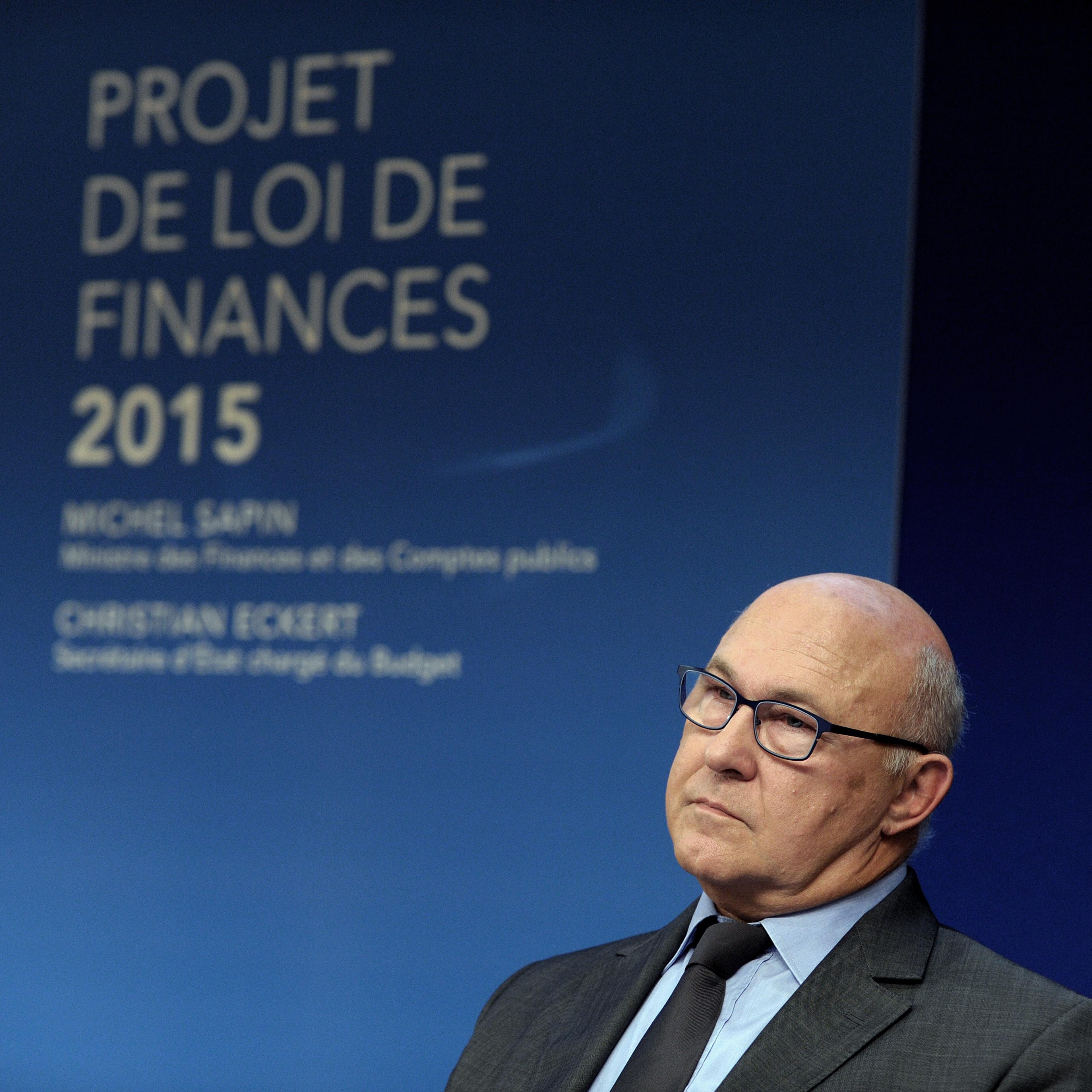 French Finance Minister Michel Sapin listens during the presentation of France's 2015 draft budget on October 1, 2014 at the Economy Ministry in Paris.