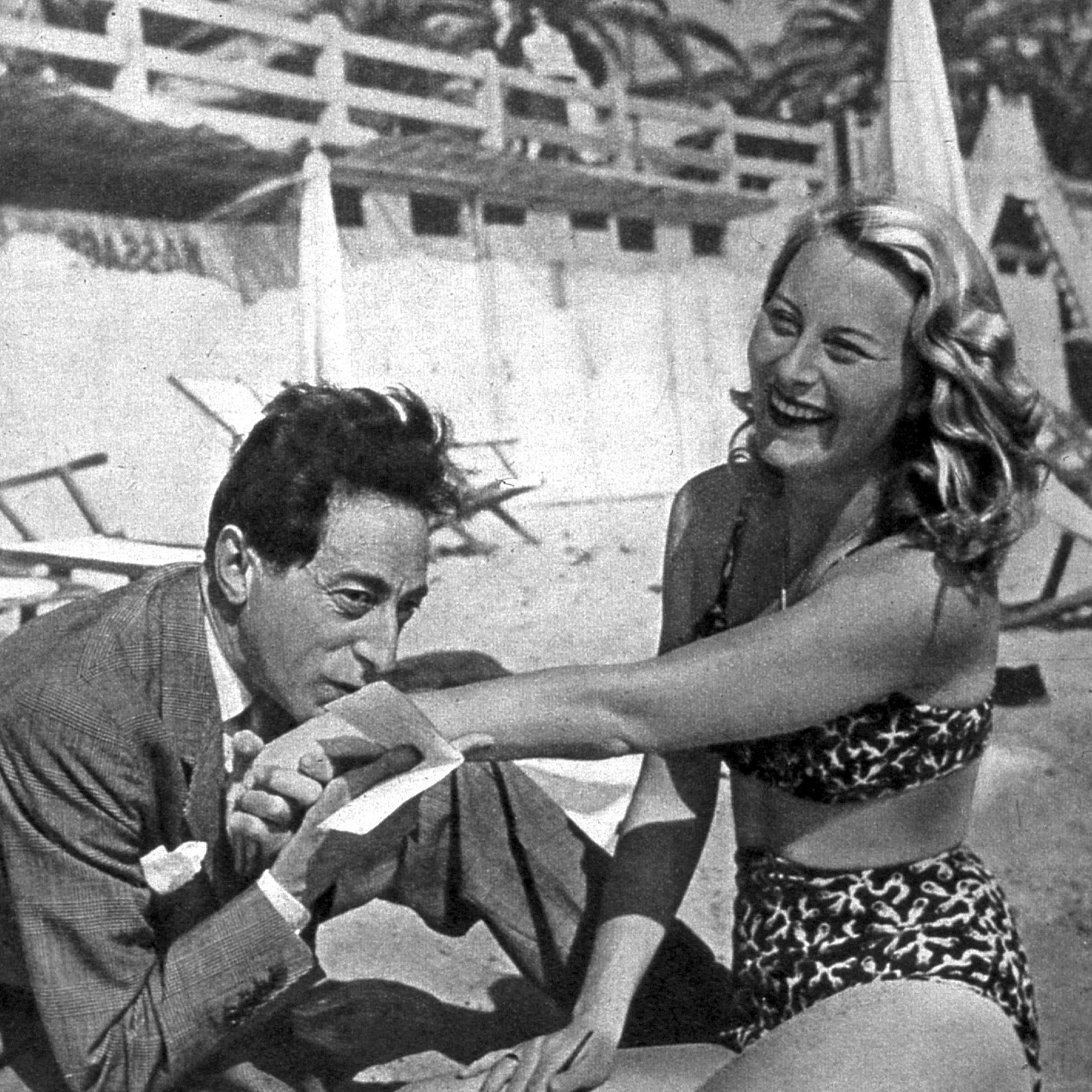 French actress Michele Morgan with artist and filmmaker Jean Cocteau on the beach during the Cannes Film Festival, 1946.