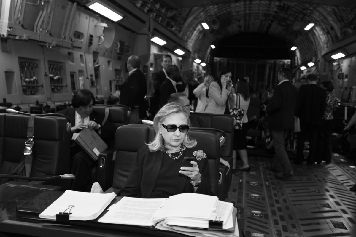Hillary checks her messages upon departure from Malta for the as-yet-undisclosed location, Tripoli, Oct. 18, 2011. This photo was turned into a meme that circulated around the world. 