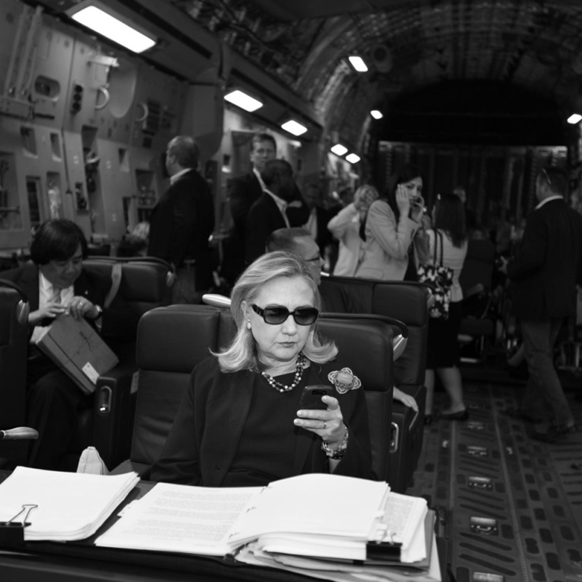 Hillary checks her messages upon departure from Malta for the as-yet-undisclosed location, Tripoli, Oct. 18, 2011. This photo was turned into a meme that circulated around the world.