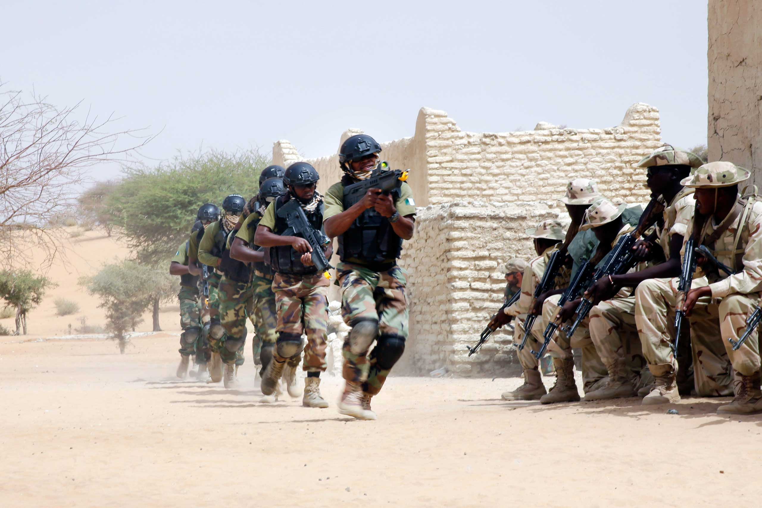 Nigerian special forces run past Chadian troops in a hostage rescue exercise at the end of the Flintlock exercise in Mao, Chad on March 7, 2015.