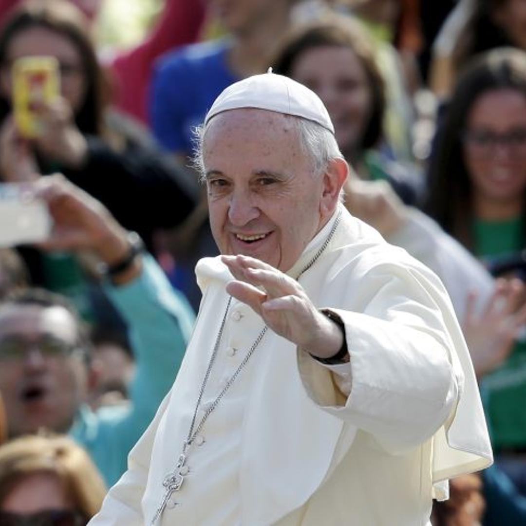 Pope Francis waves as he arrives to lead his Wednesday general audience in Saint Peter's Square at the Vatican