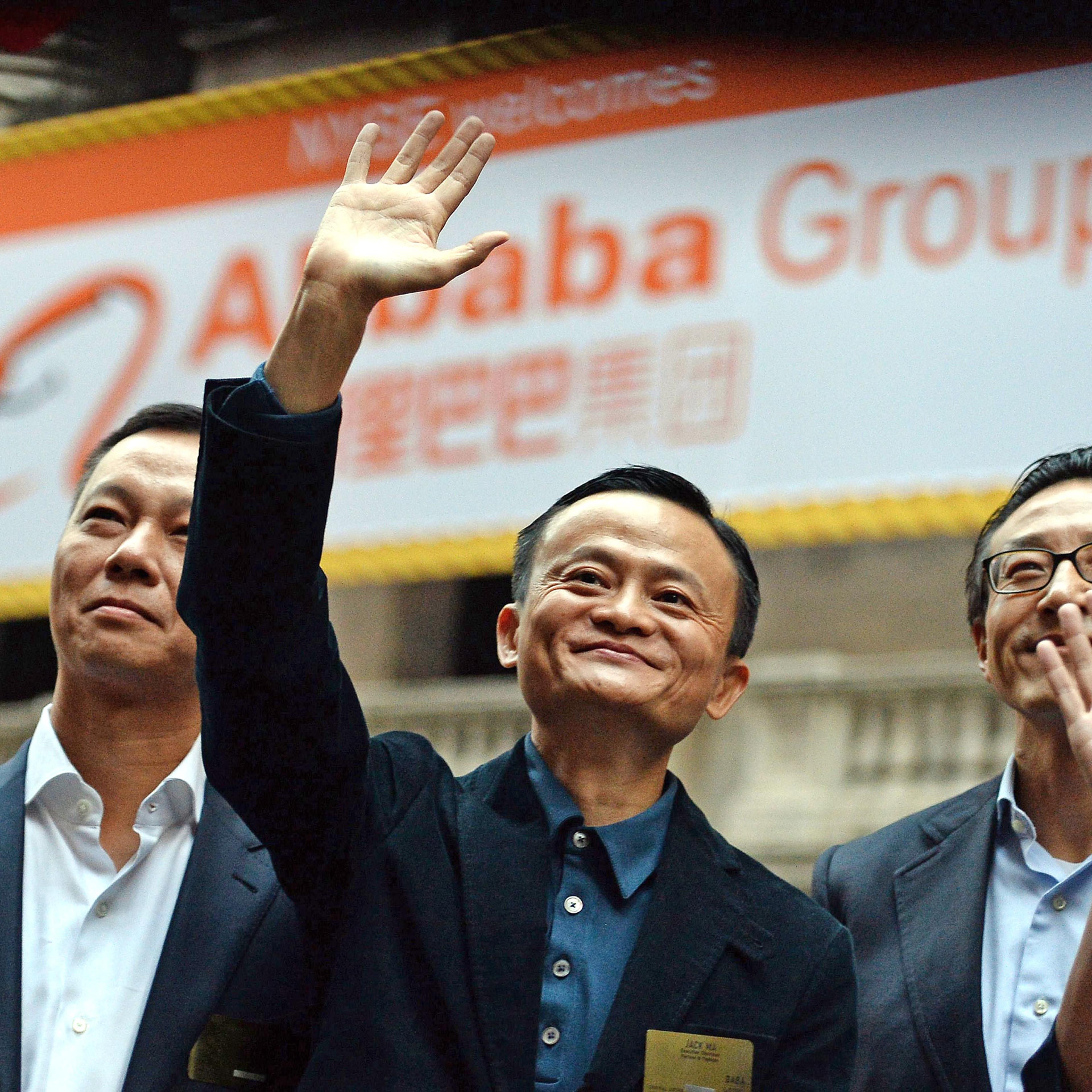 Chinese online retail giant Alibaba CEO Jack Ma (center) waves as he arrives at the New York Stock Exchange in New York City on Sept. 19, 2014.