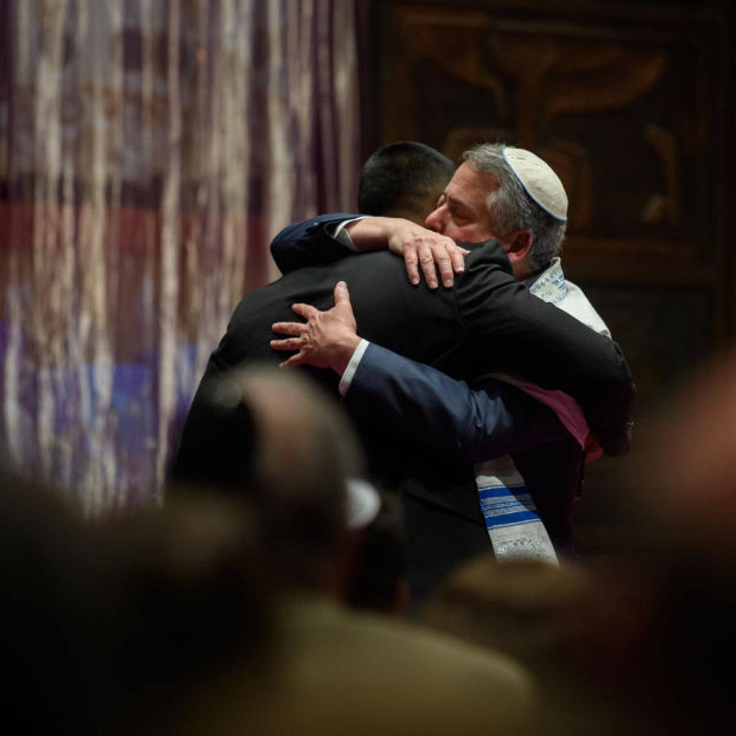 Rabbi Jamie Gibson and Wasi Mohamed embrace