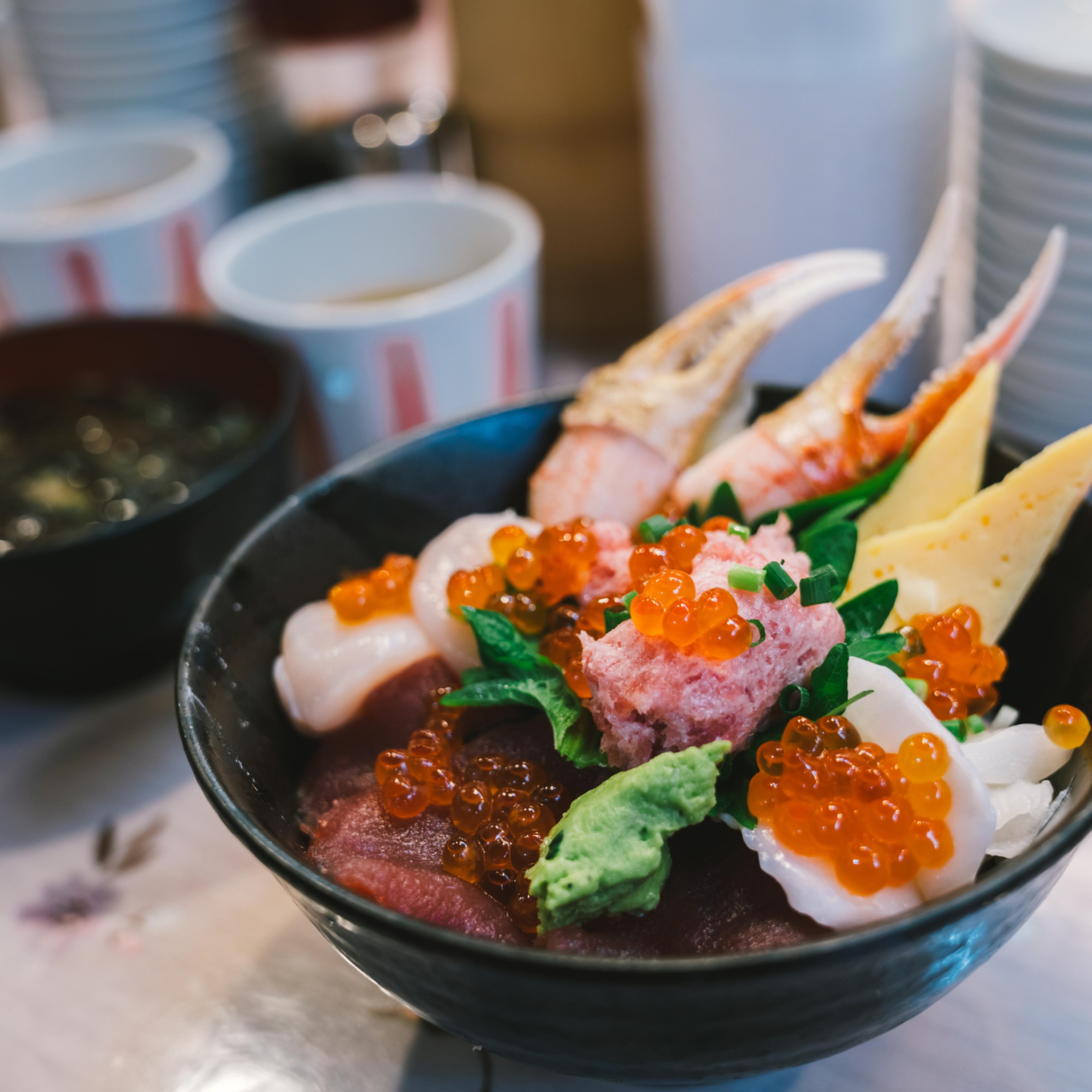 Chirashi Sushi Don or sashimi donburi, Japanese seafood rice bowl topped with mixed raw tuna fish, salmon roe, hotate scallop, engawa, crab claw meat, and wasabi. Japan famous traditional food concept