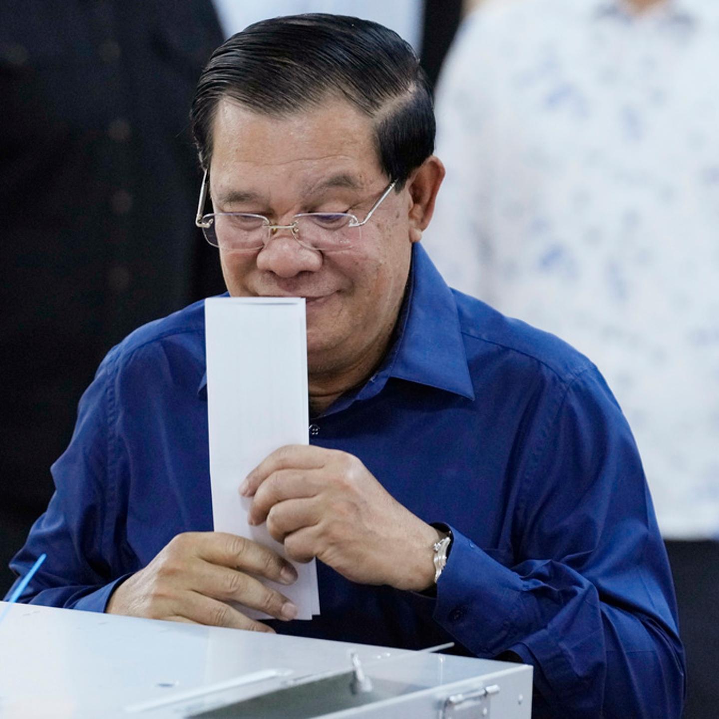 Cambodian Prime Minister Hun Sen of the Cambodian People's Party (CPP) kisses a ballot before voting at a polling station at Takhmua in Kandal province, southeast Phnom Penh, Cambodia, Sunday, July 23, 2023.