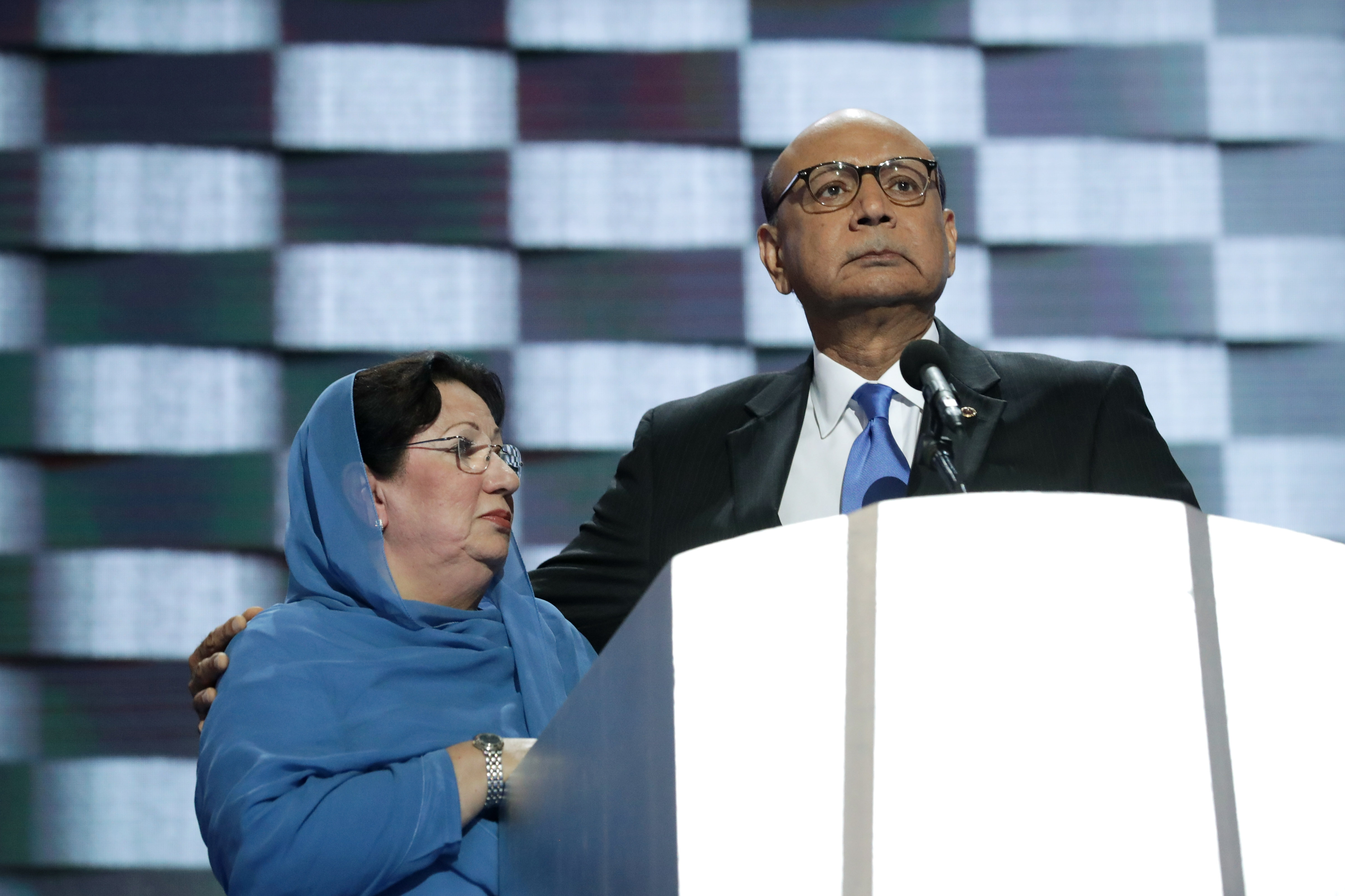 Khizr Khan, father of deceased U.S. Army Capt. Humayun S. M. Khan, delivers remarks as he is joined by his wife Ghazala Khan on the fourth day of the Democratic National Convention at the Wells Fargo Center in Philadelphia on July 28, 2016.