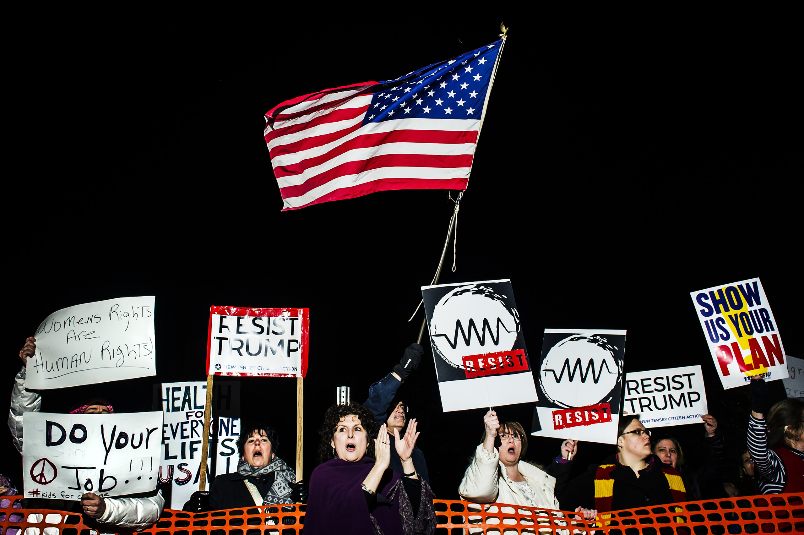 Angry constituents hold signs at a town hall at Raritan Valley Community College in Branchburg, NJ., Feb. 22, 2017