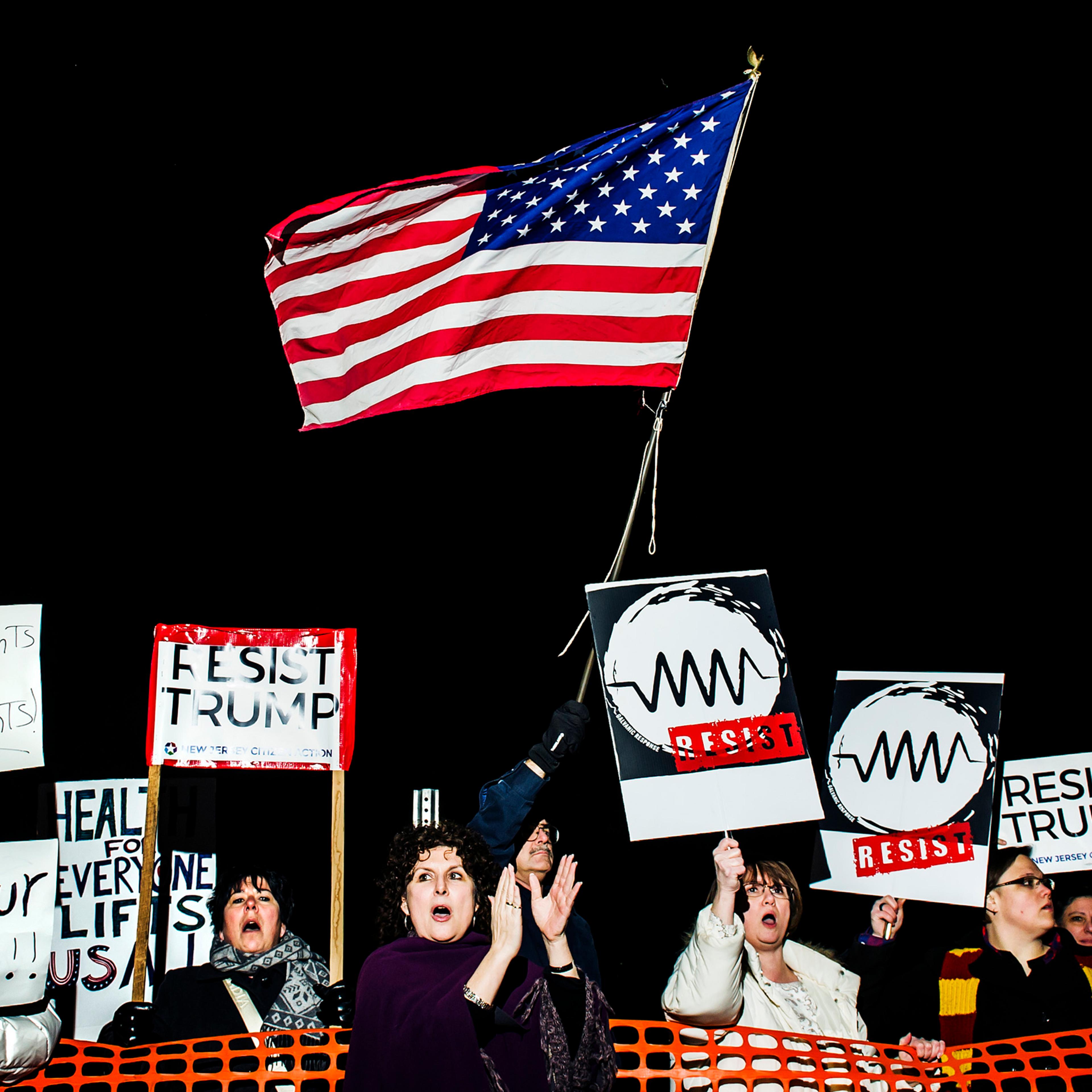 Angry constituents hold signs at a town hall at Raritan Valley Community College in Branchburg, NJ., Feb. 22, 2017
