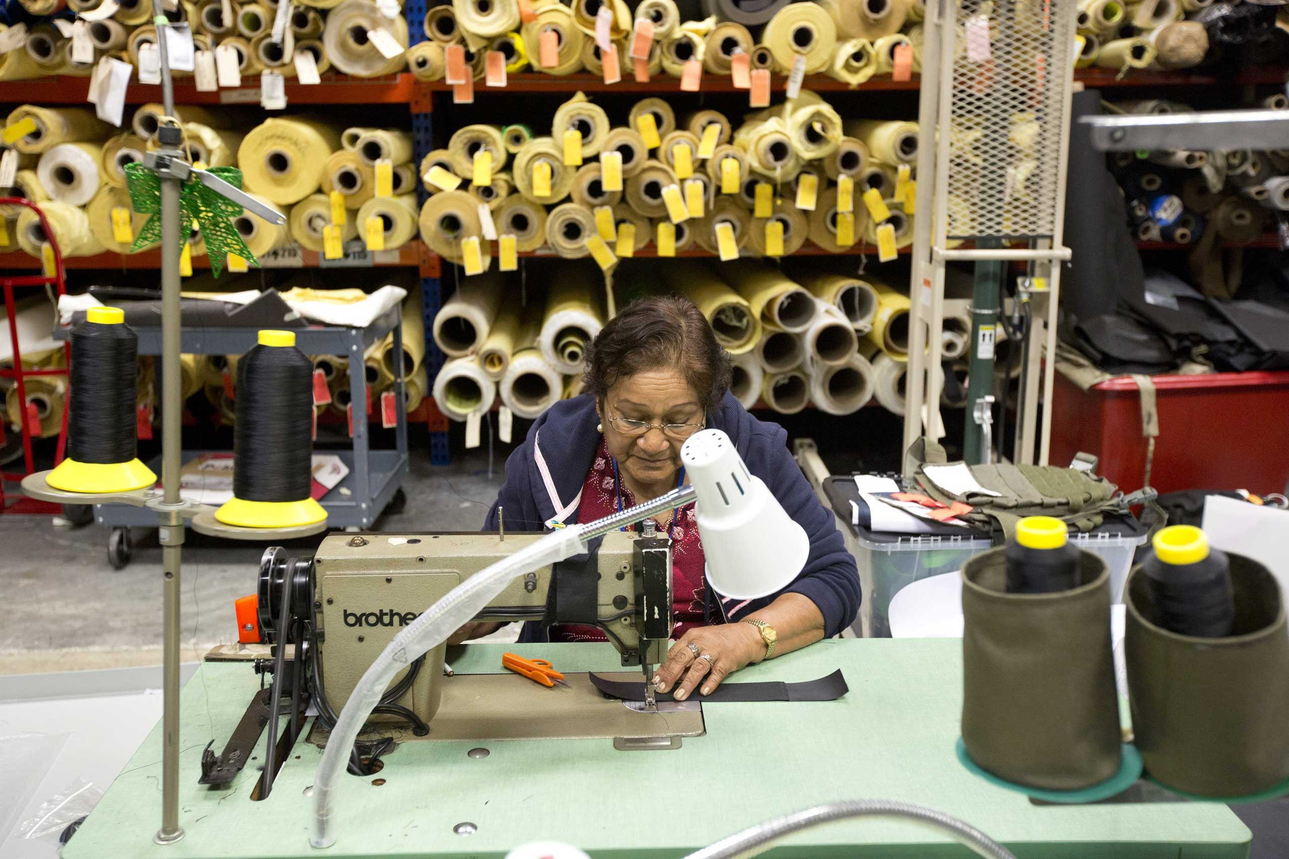 Rosa Pantoja sews a bullet proof vest together in the Research and Development department of the Point Blank Body Armor factory in Pompano Beach, Fla., Sept. 19, 2014