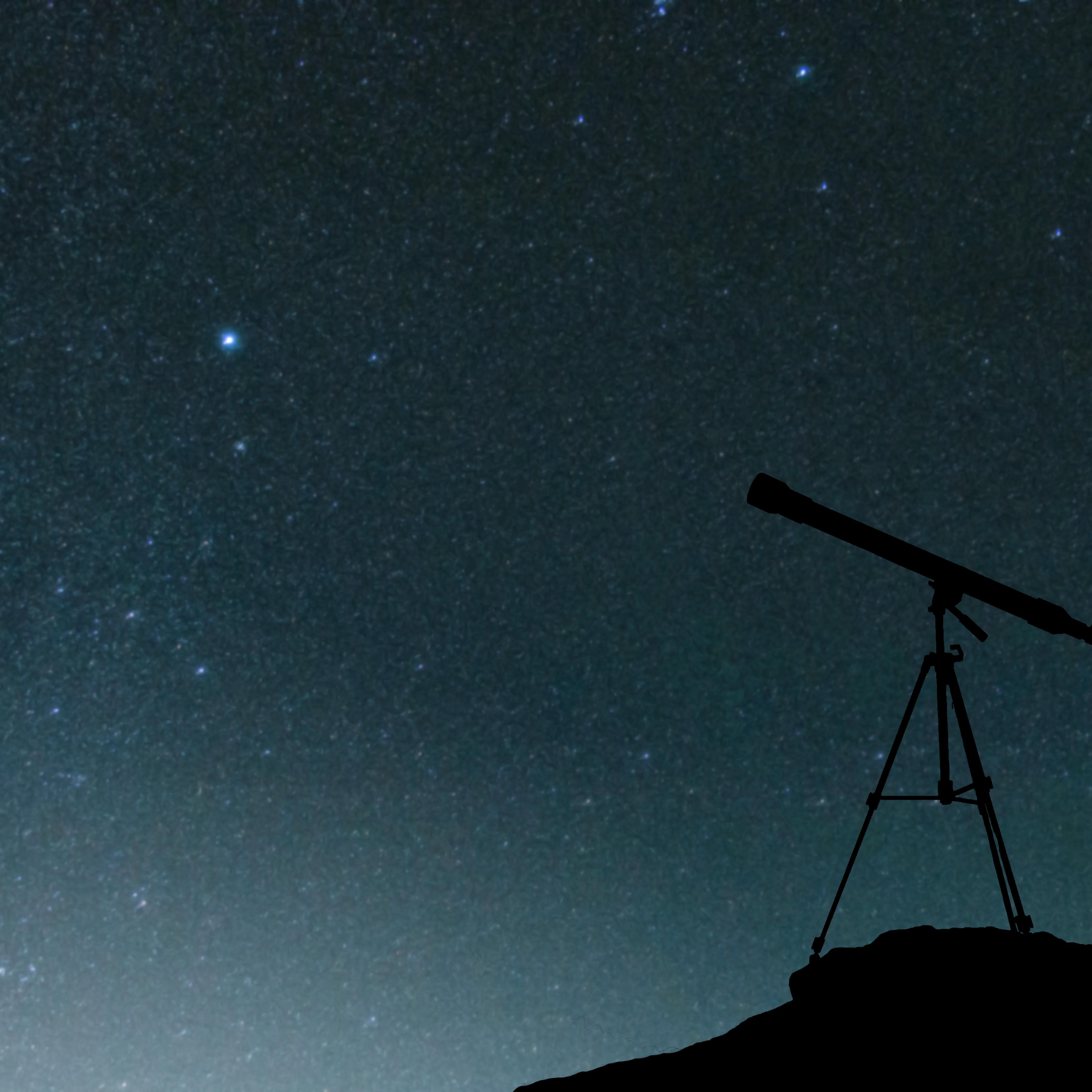 Silhouette Friends Using Telescope Against Star Field At Night