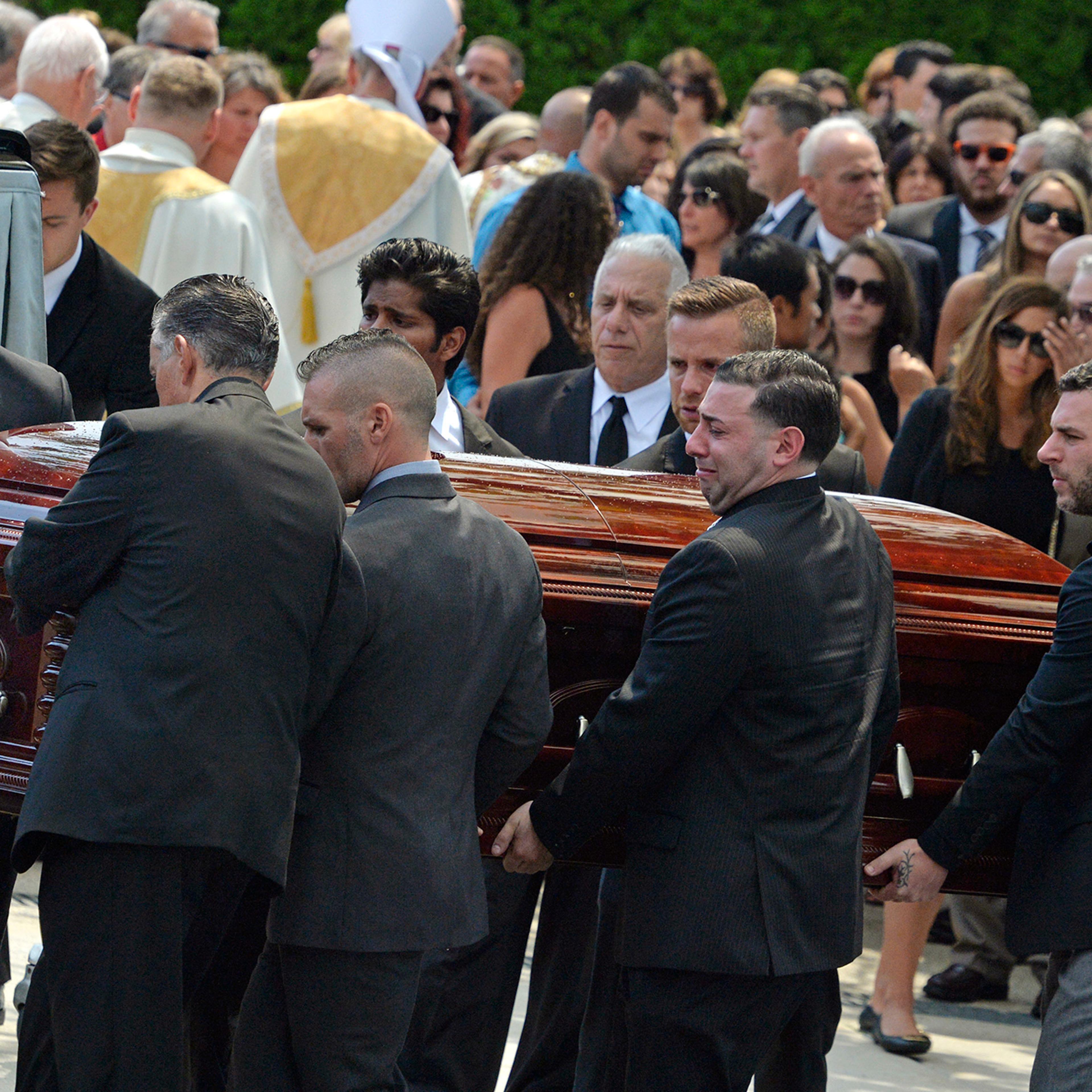 Mourners carry the casket of Karina Vetrano from St. Helen's Church following her funeral in Queens, New York on Aug. 6, 2016. Vetrano was killed while running alone during daylight hours through a Queens park the previous week.