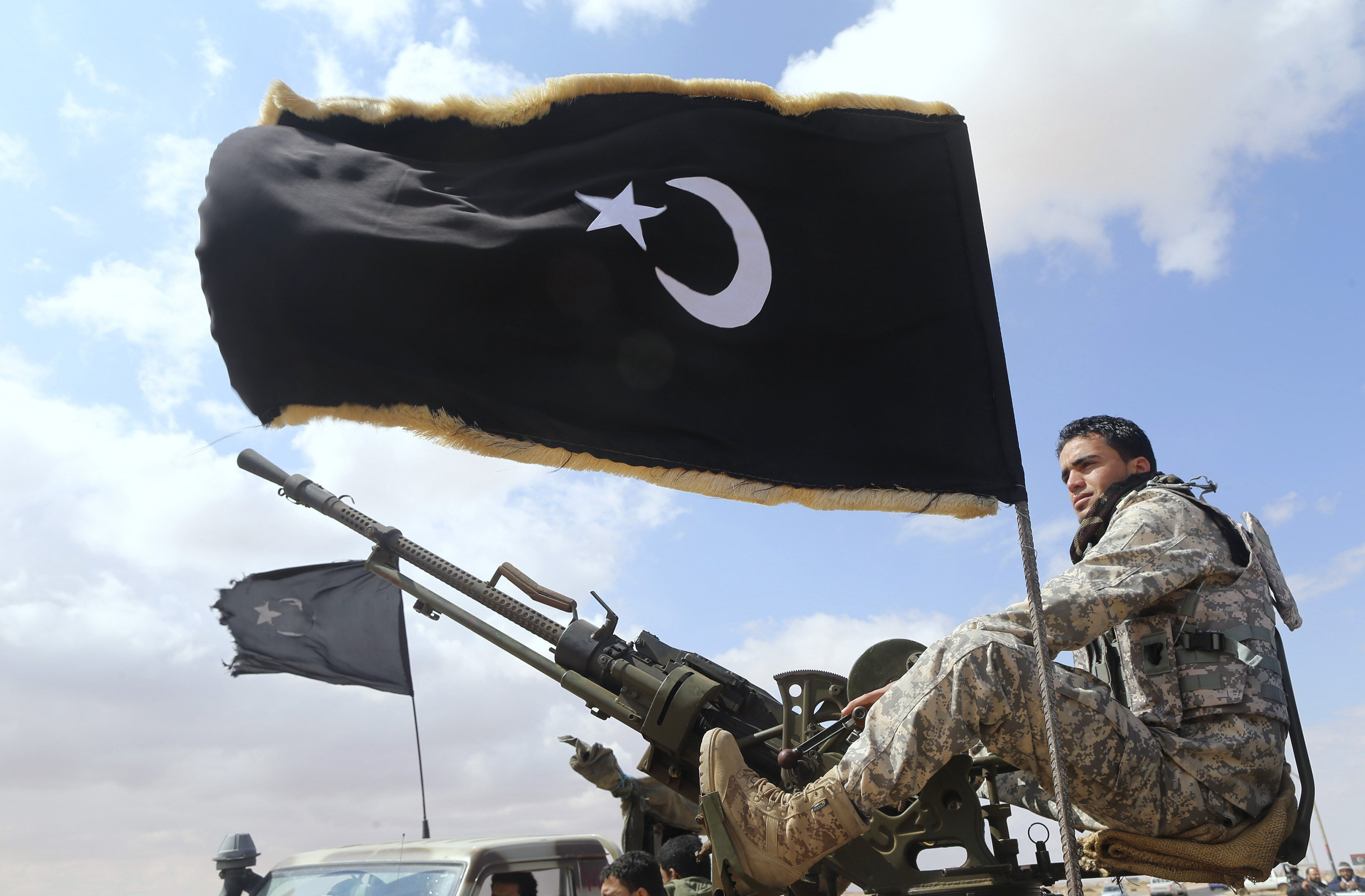 A rebel under Ibrahim Jathran guards the entrance of Es Sider port in Ras Lanuf