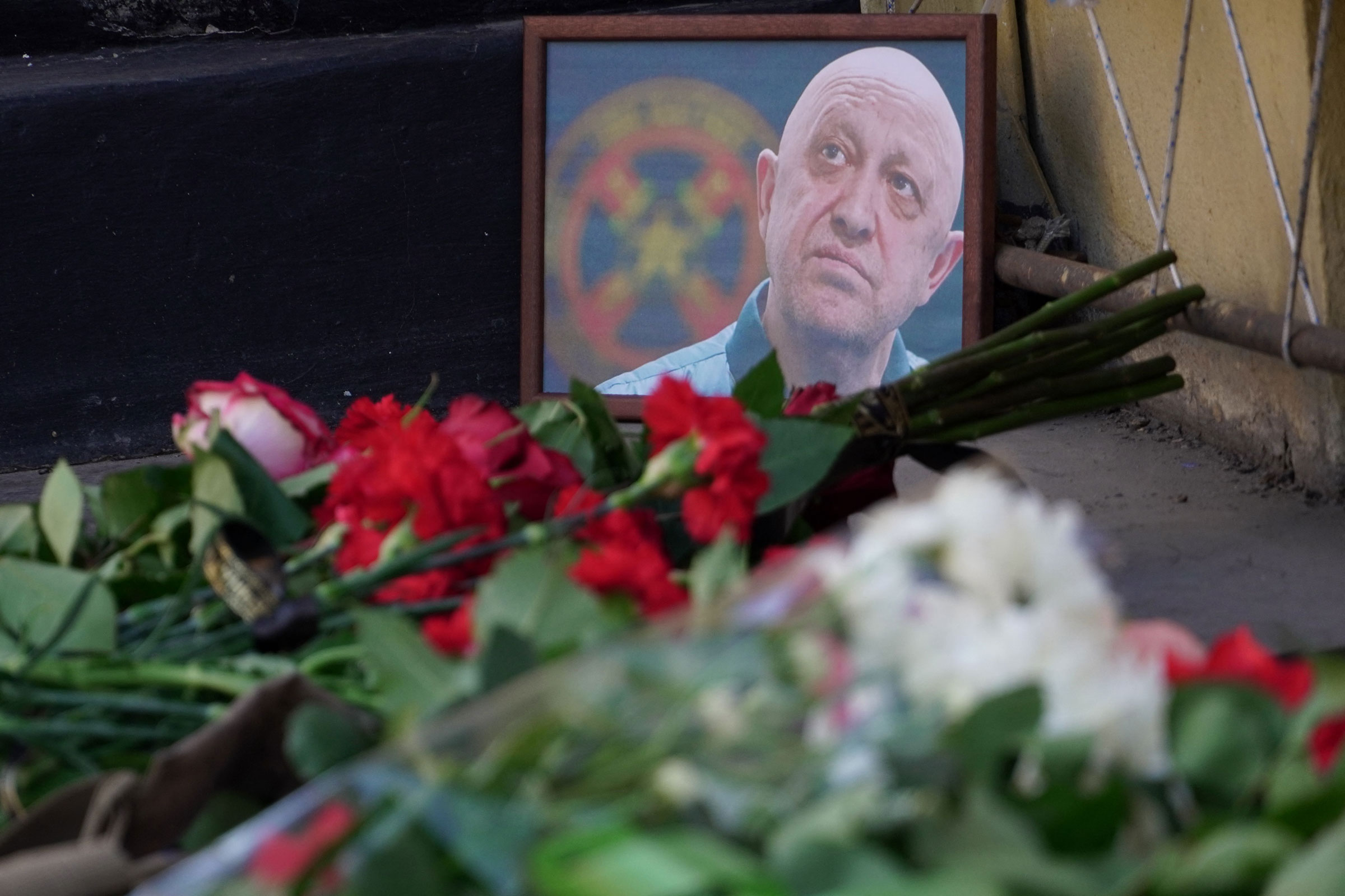 A portrait of Yevgeny Prigozhin is seen at the makeshift memorial