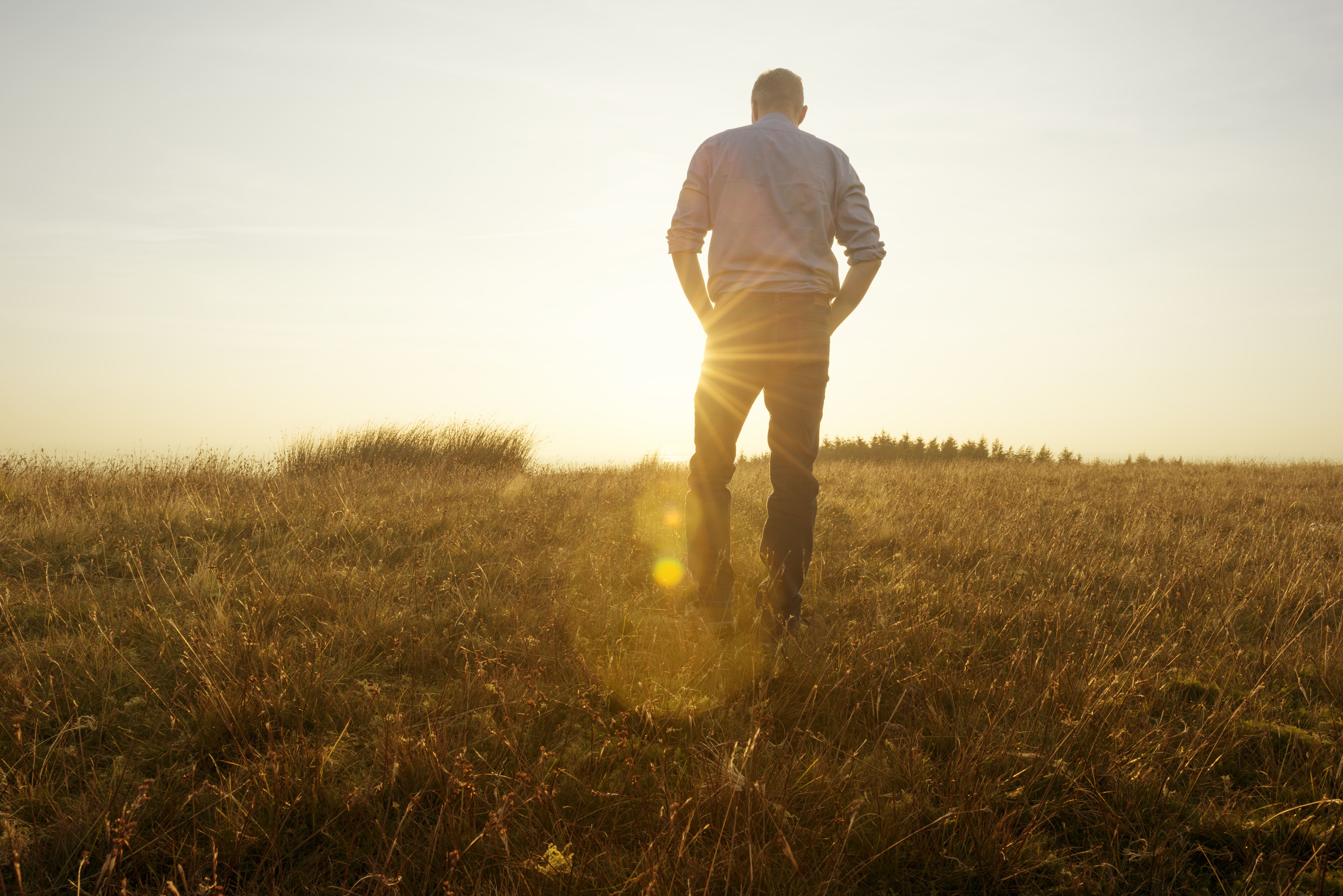 man-standing-sunset