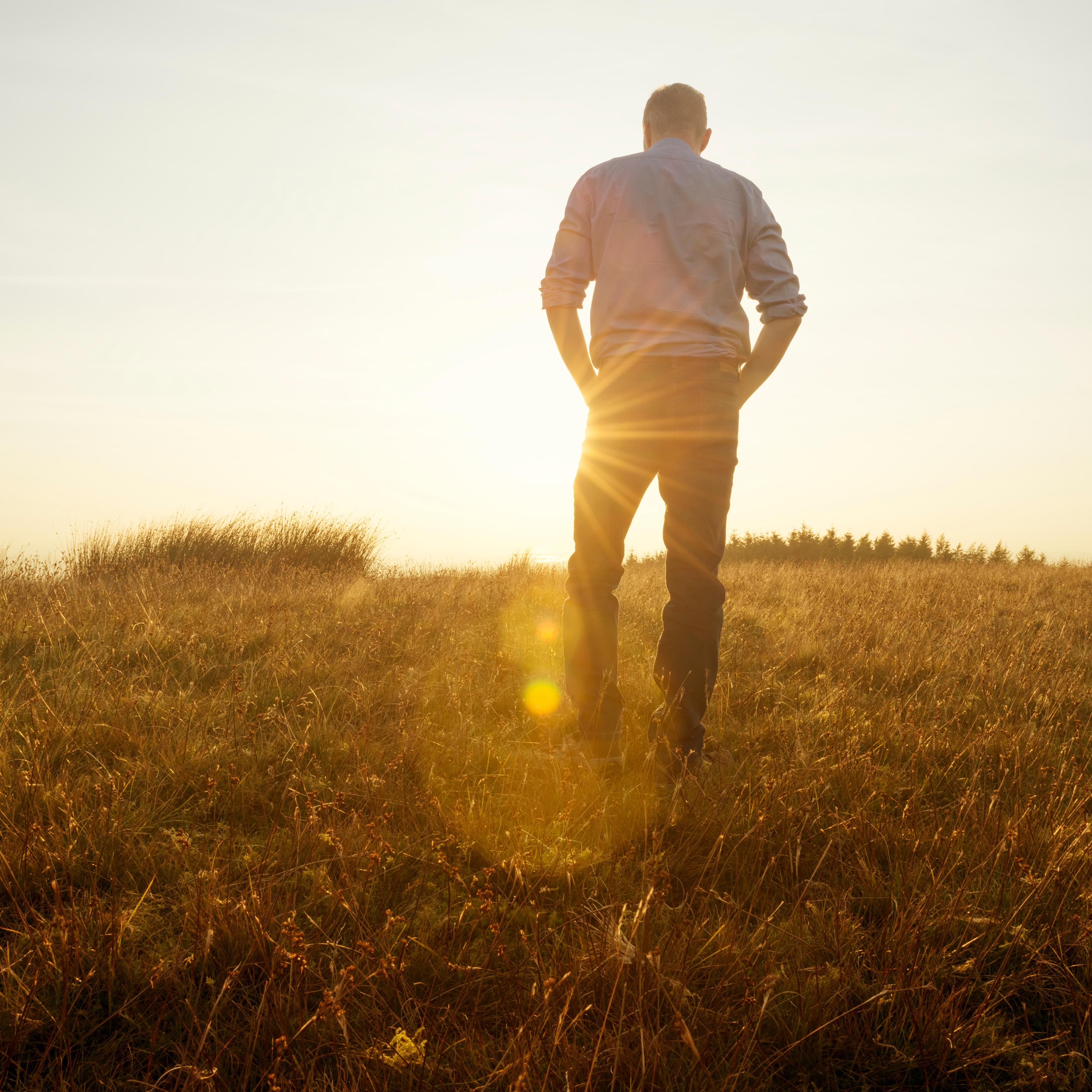 man-standing-sunset