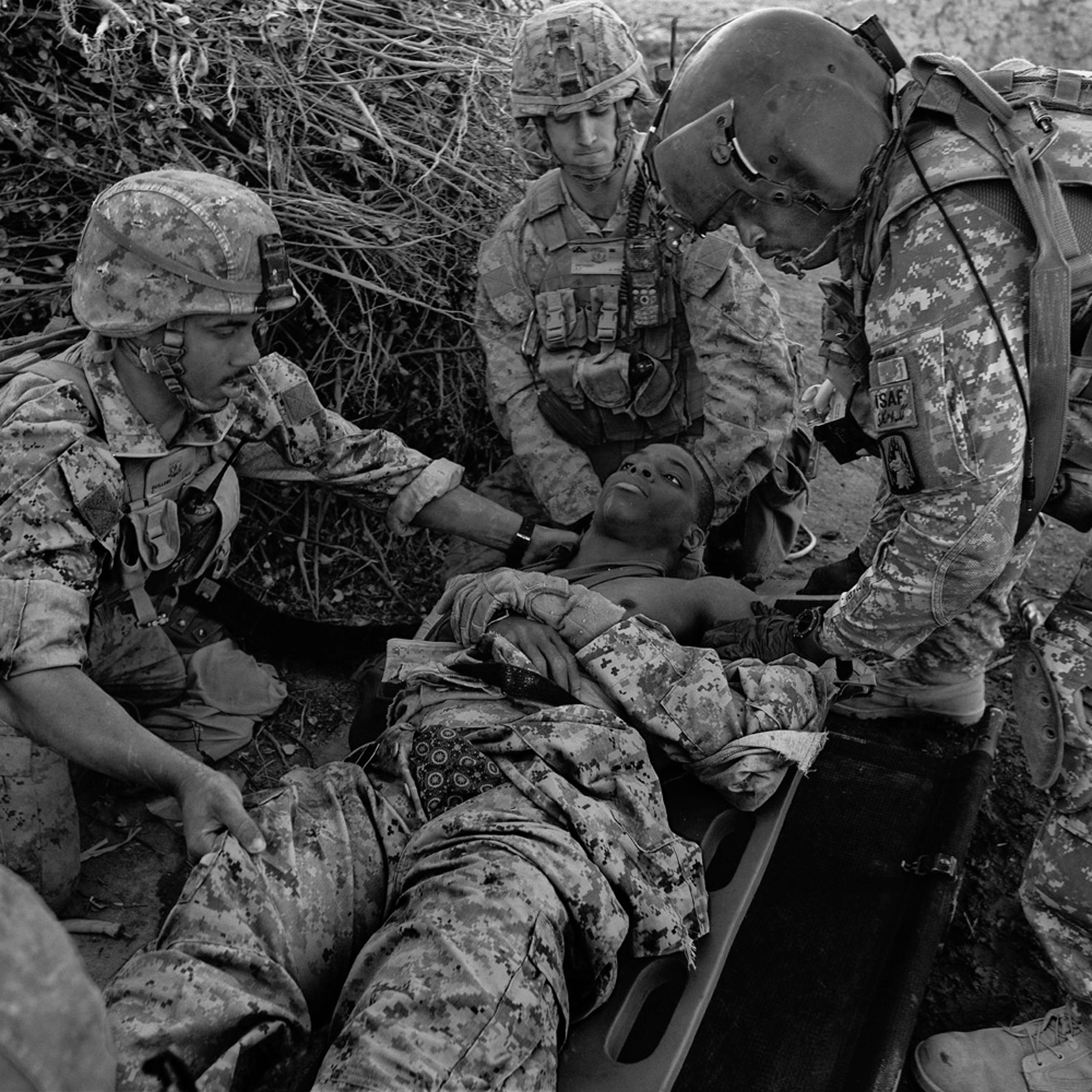 Medevac crew members prepare to evacuate a wounded Marine in Helmand province in 2010