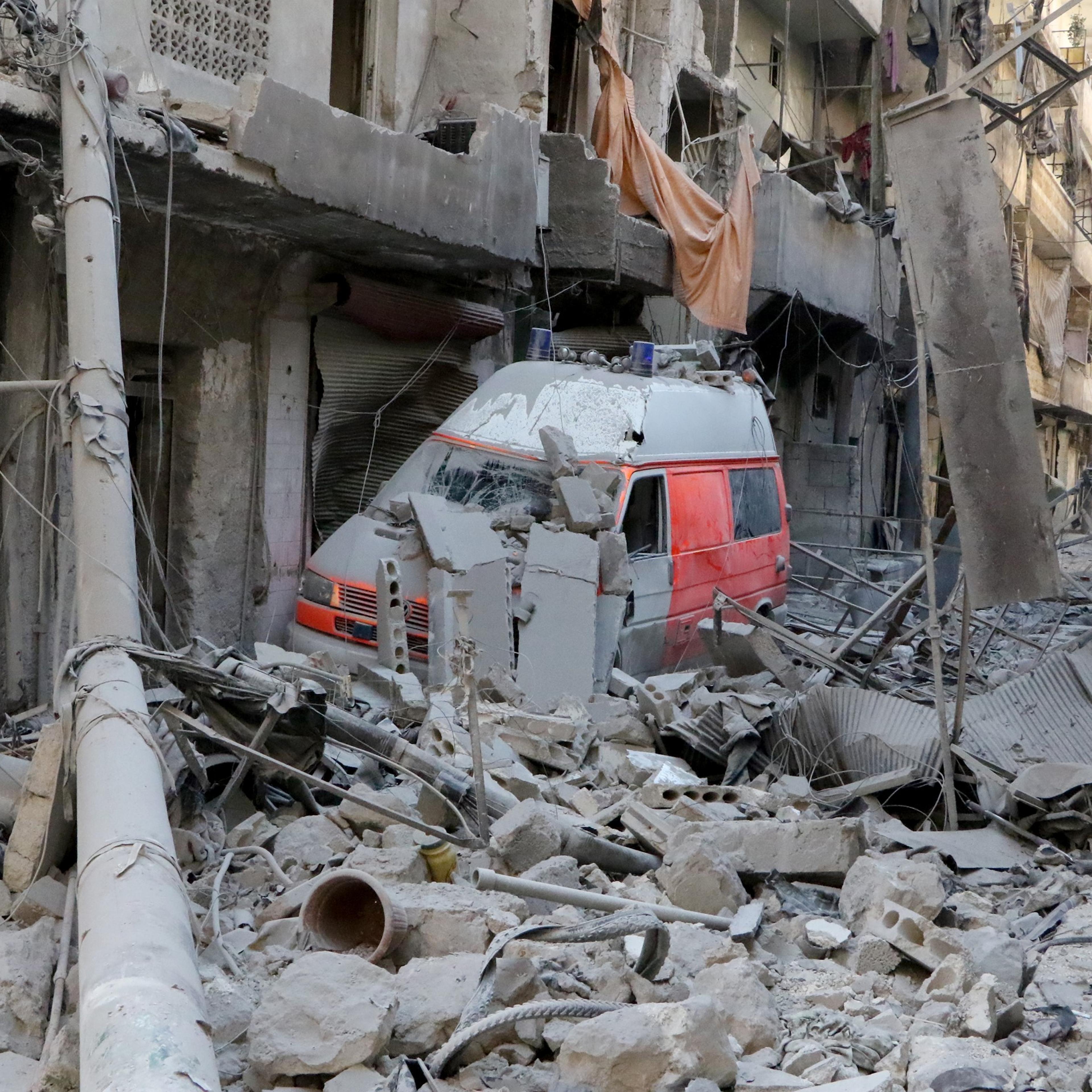 A wrecked ambulance is seen inside the debris of collapsed buildings after the Russian army hit the residential area with cluster bombs over opposition controlled Salihin neighborhood of Aleppo, Syria on Sept. 11, 2016.