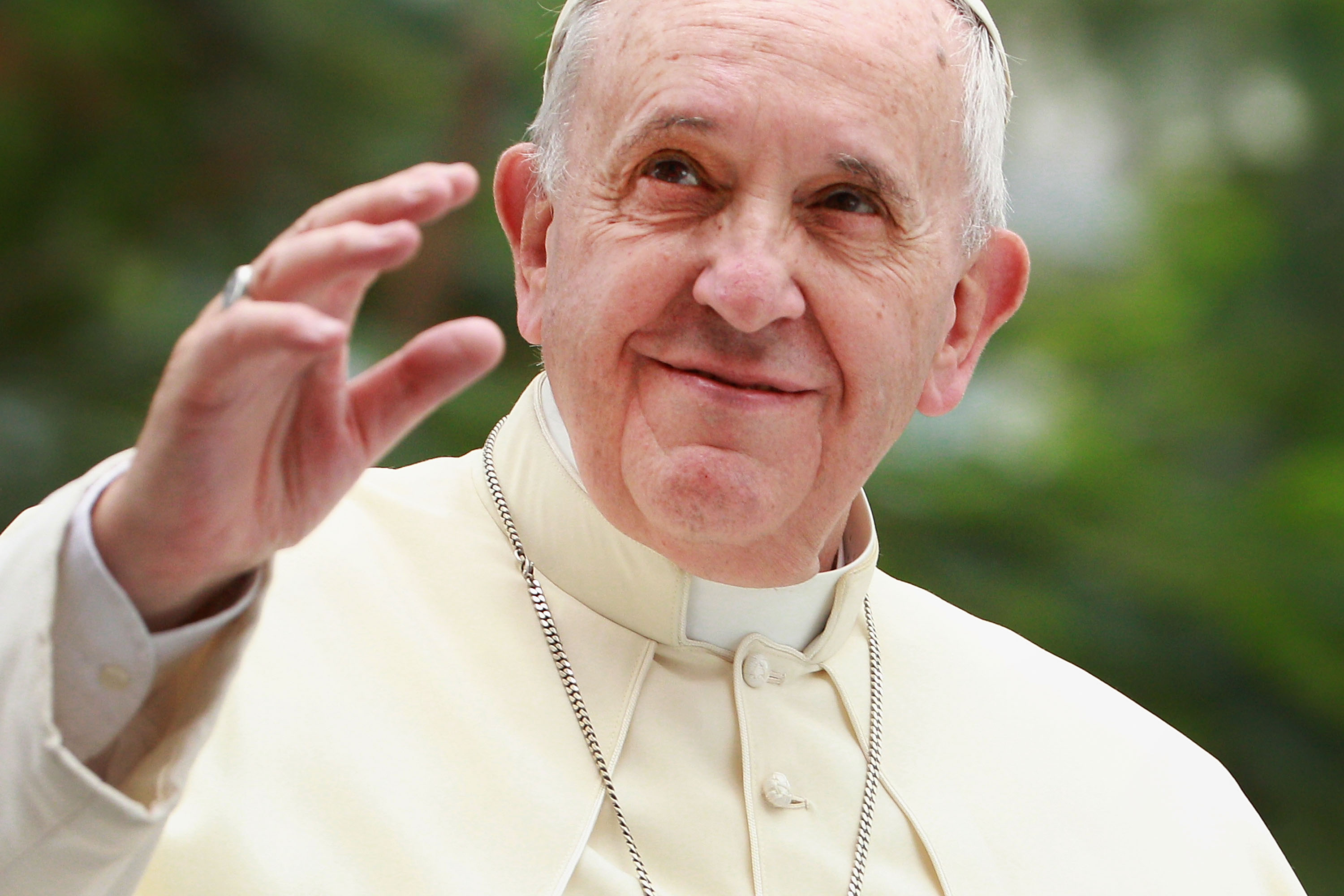 Pope Francis waves to thousands of followers as he arrives at the Manila Cathedral on January 16, 2015 in Manila, Philippines.