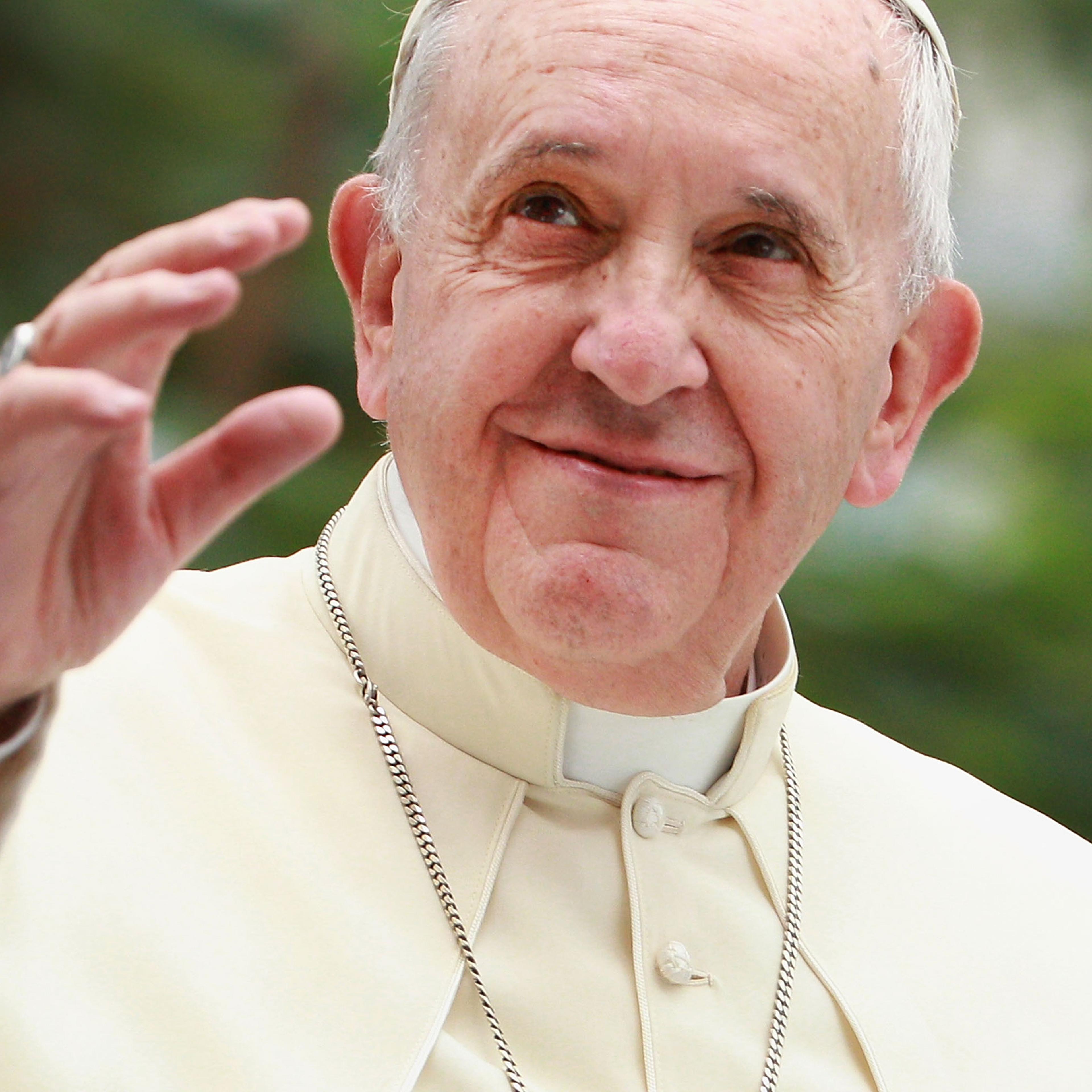 Pope Francis waves to thousands of followers as he arrives at the Manila Cathedral on January 16, 2015 in Manila, Philippines.