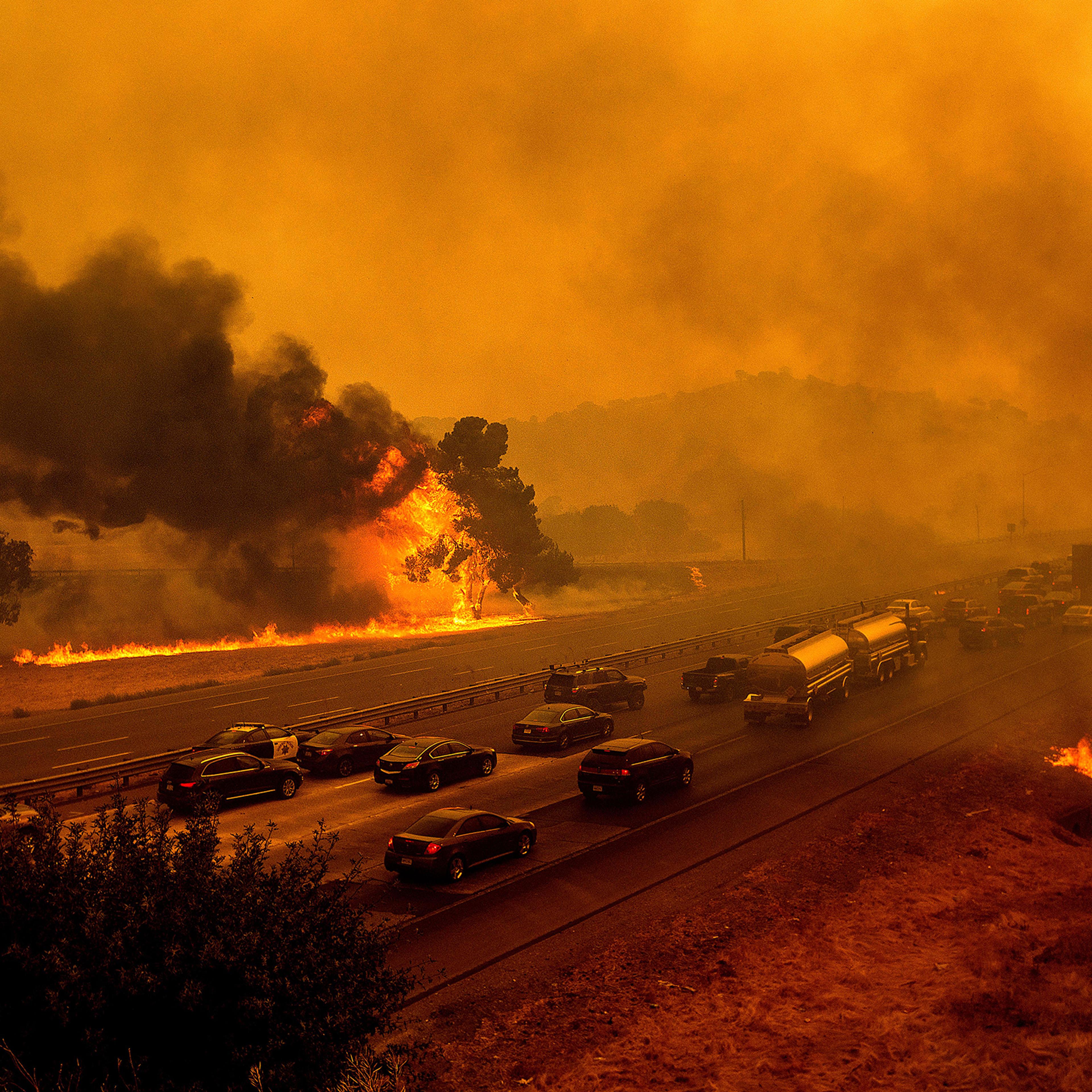 Flames from the LNU Lightning Complex fires along Interstate 80 in Vacaville, Calif., on Aug. 19, 2020. The highway was closed in both directions shortly afterward.