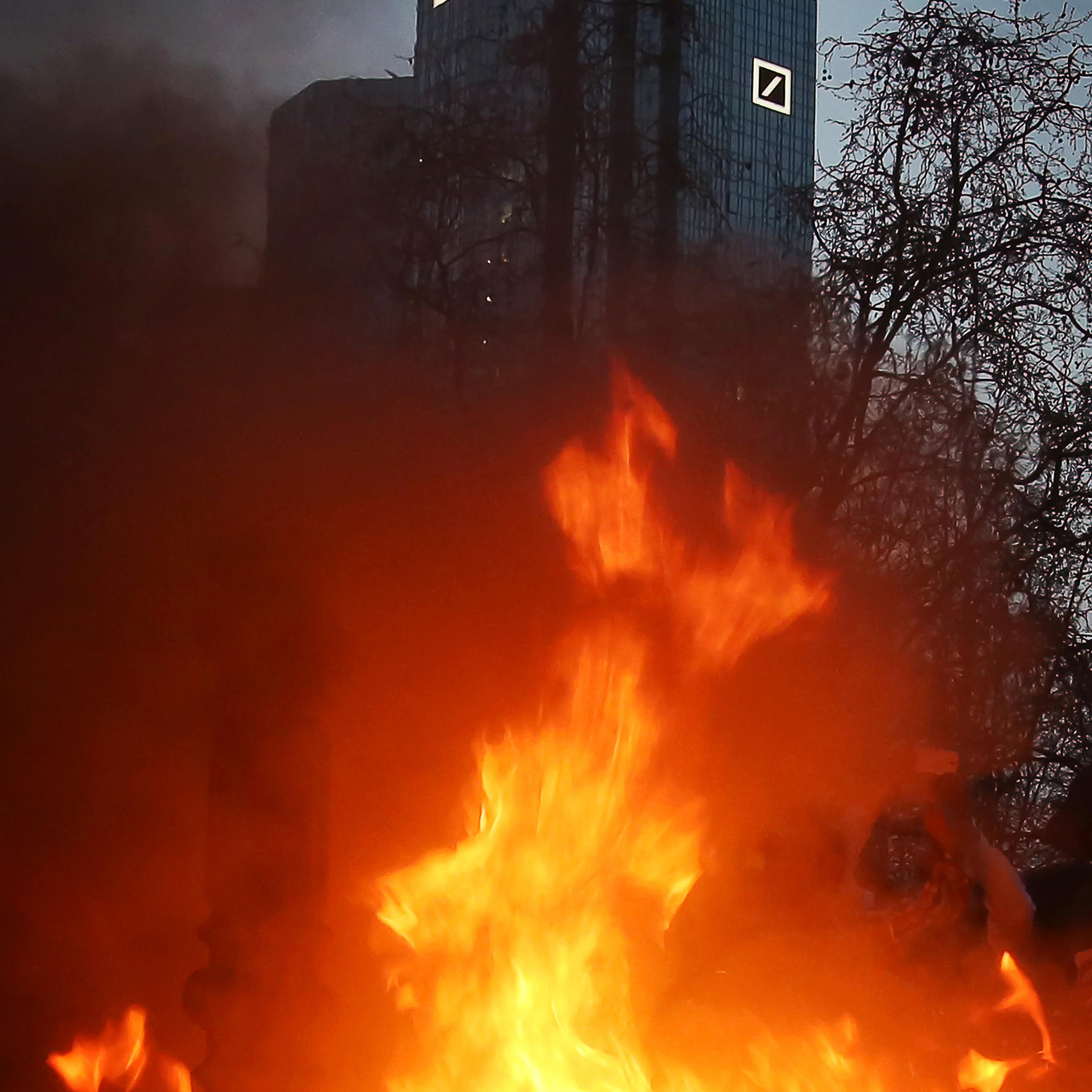 Anti-austerity protesters started the fire, burning fake money in the shadow of the Deutsche Bank towers in Frankfurt in March 2015