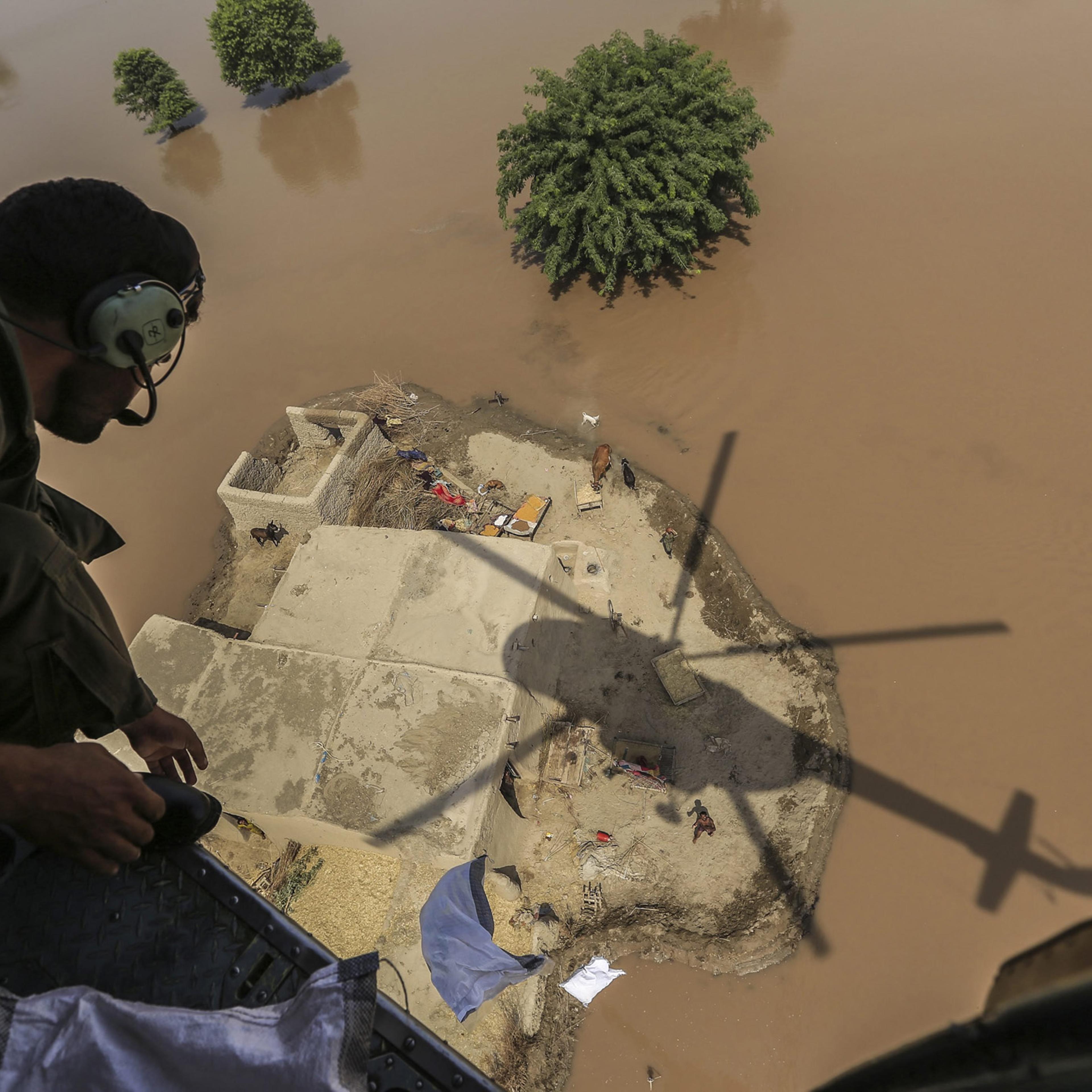 A Pakistani Army soldier distributes food bags in flooded areas in Shujabad, on the outskirts of Multan, Pakistan, Sept. 15, 2014.