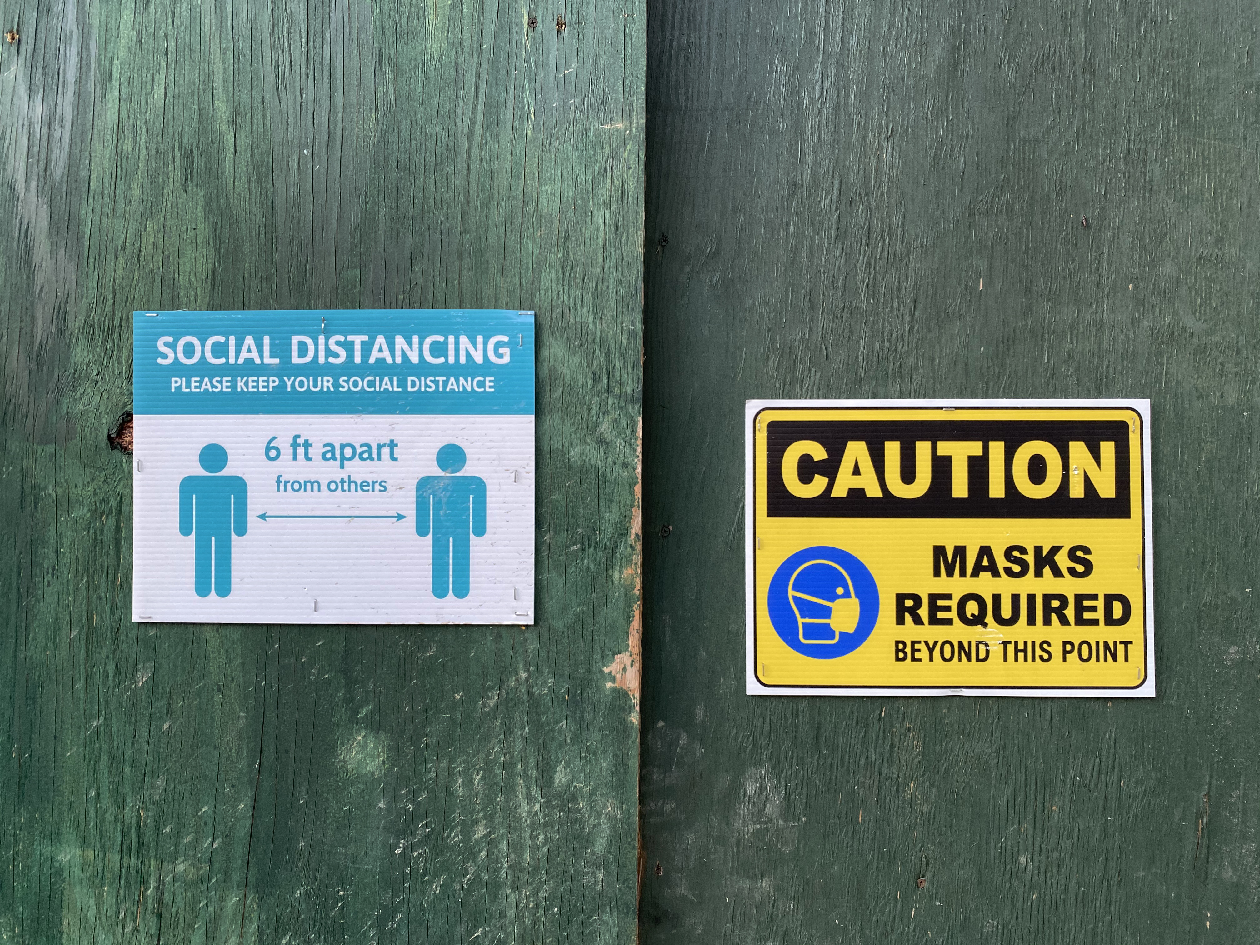 Caution sign, masks and social distancing required, construction site, Queens, NY