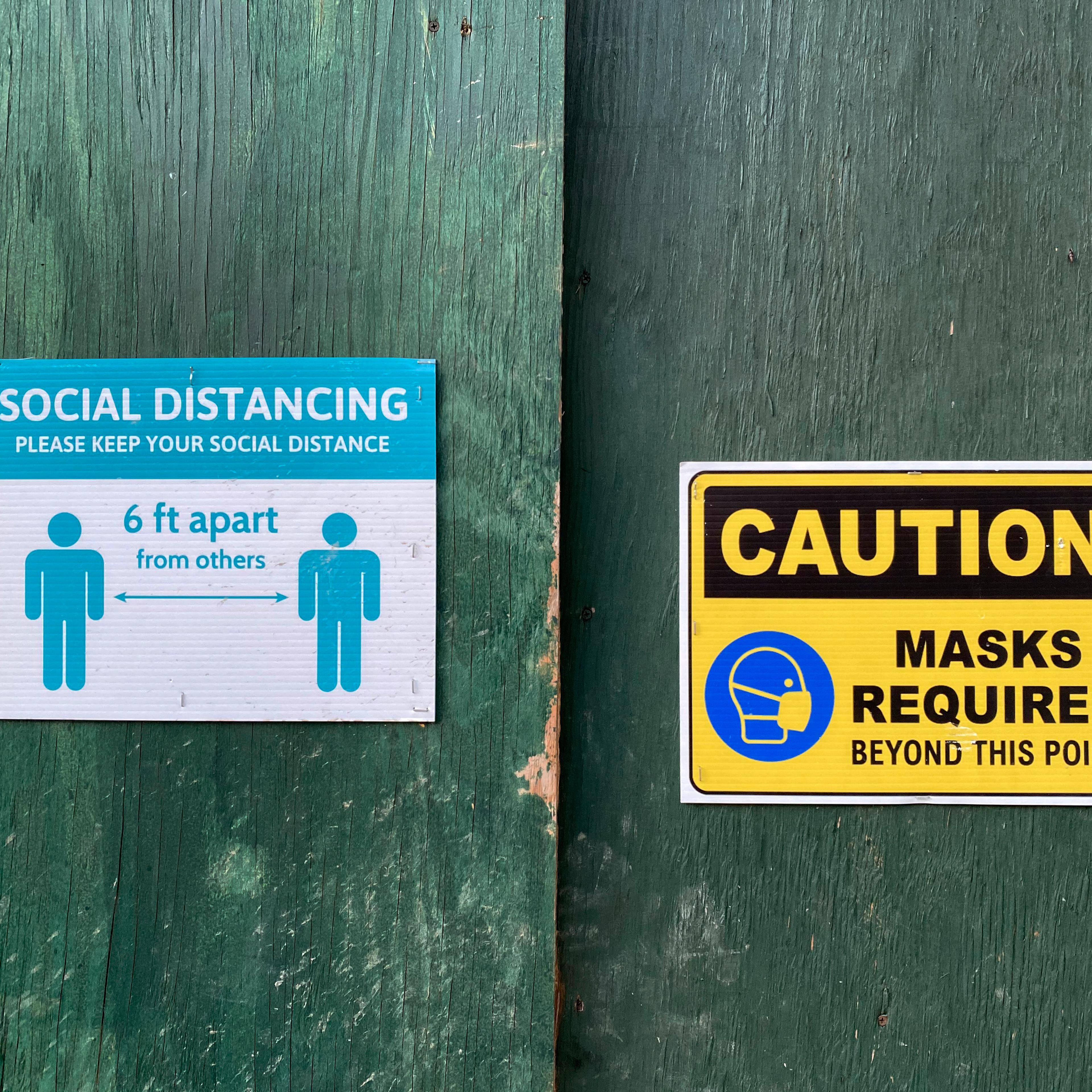 Caution sign, masks and social distancing required, construction site, Queens, NY