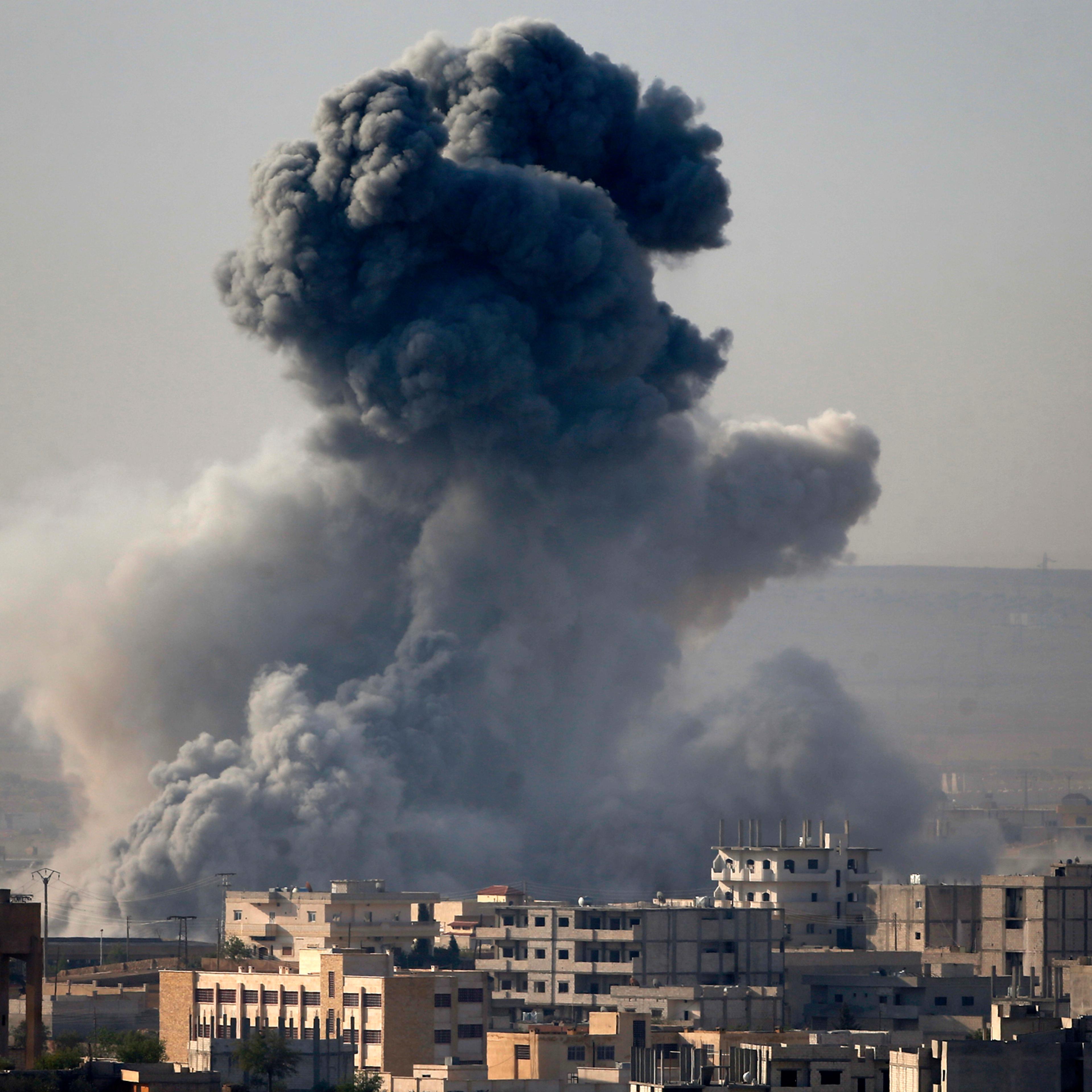 Smoke rises from the Syrian town of Kobani, seen from near the Mursitpinar border crossing on the Turkish-Syrian border in the southeastern town of Suruc